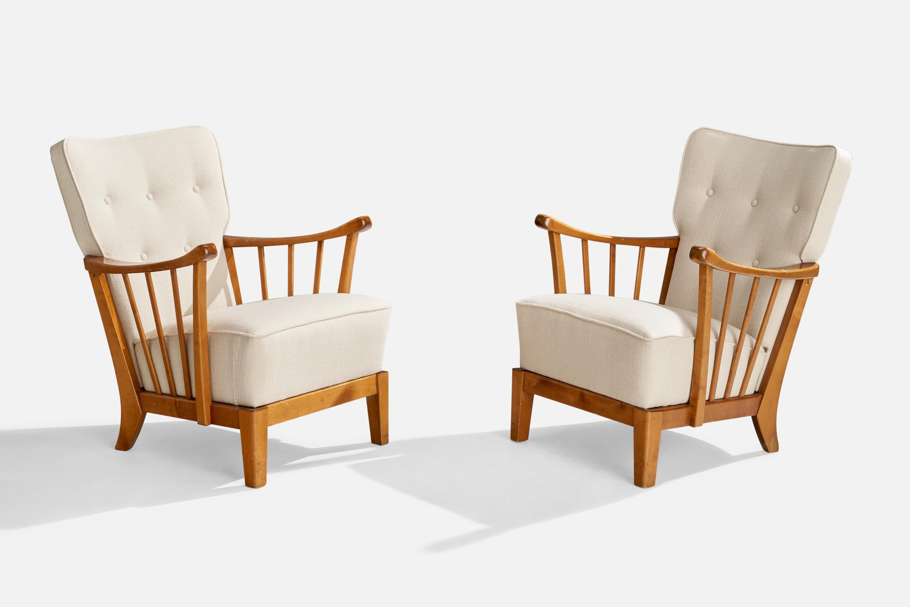 A pair of white fabric and birch lounge chairs produced by Asko, Finland, c. 1940s.

Seat height 16.5”.
