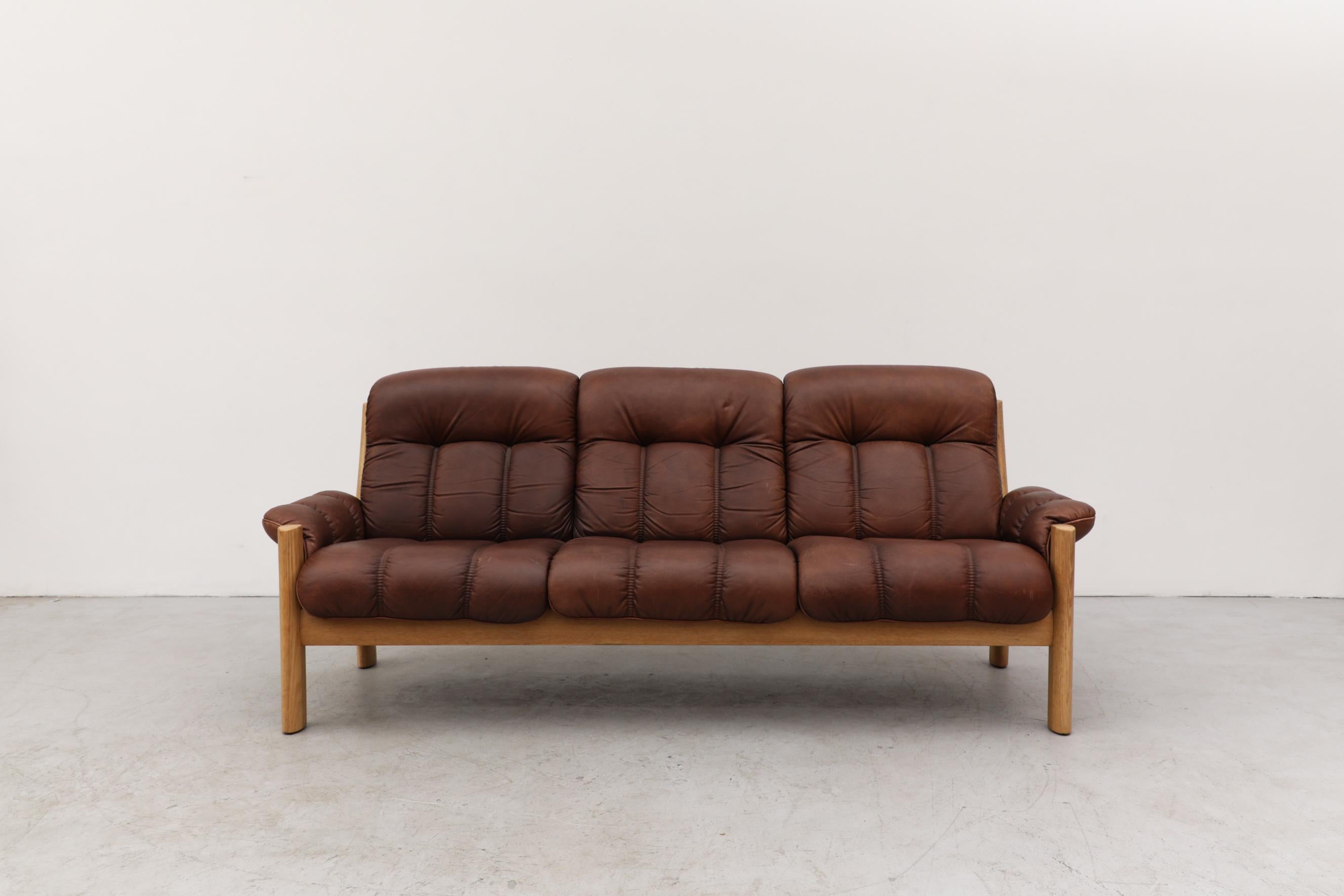 Tufted leather 3 seater oak sofa with a great patina by Finnish design company, Asko. The leather is in original condition and has some scratching and wear, consistent with its age and use.