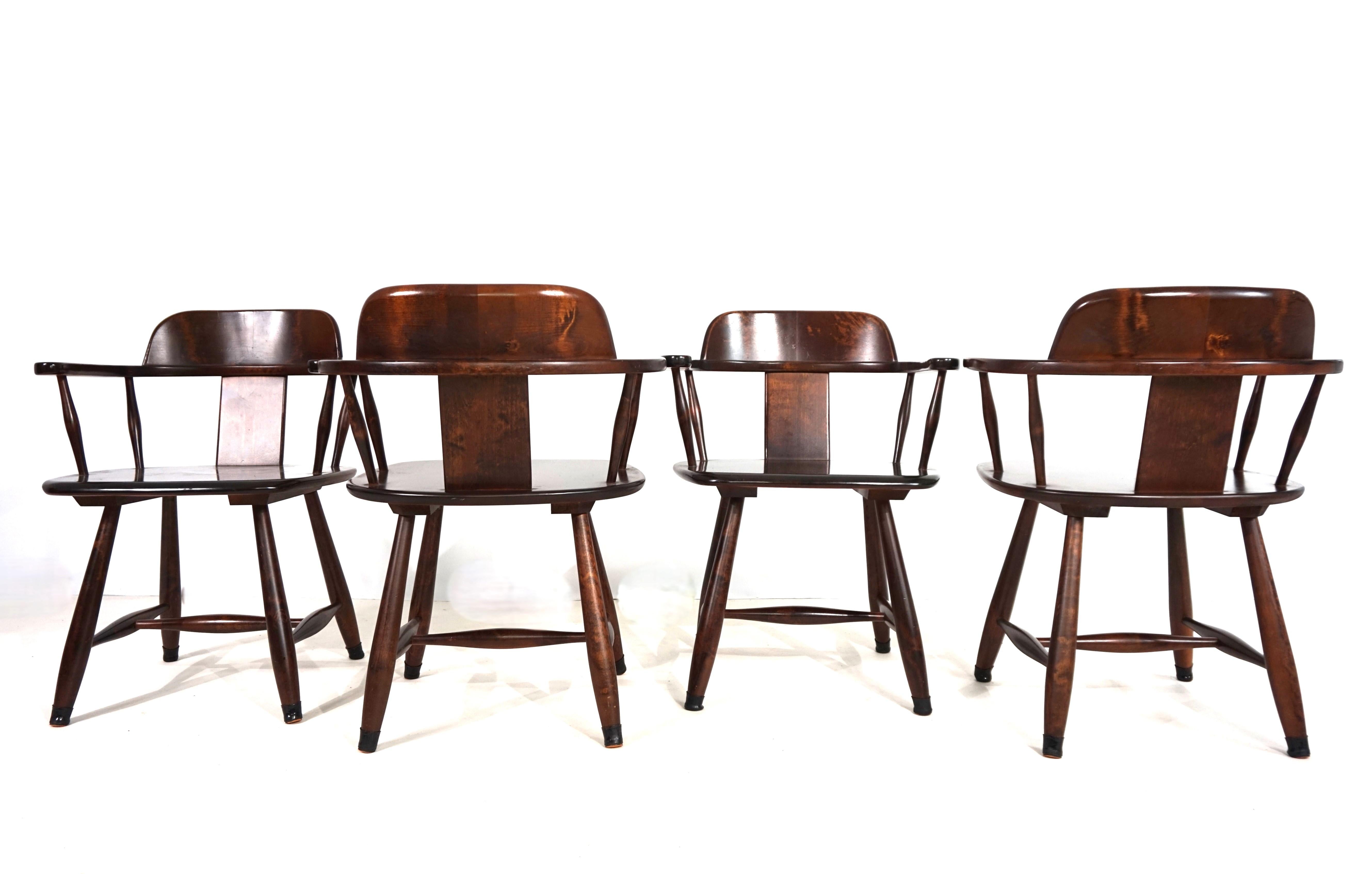 This set of four dining chairs showcases the origins of Finnish furniture. They are made of dark-patinated birchwood and feature a beautiful grain with a fantastic play of colors. They show minimal signs of wear and are solidly constructed. The
