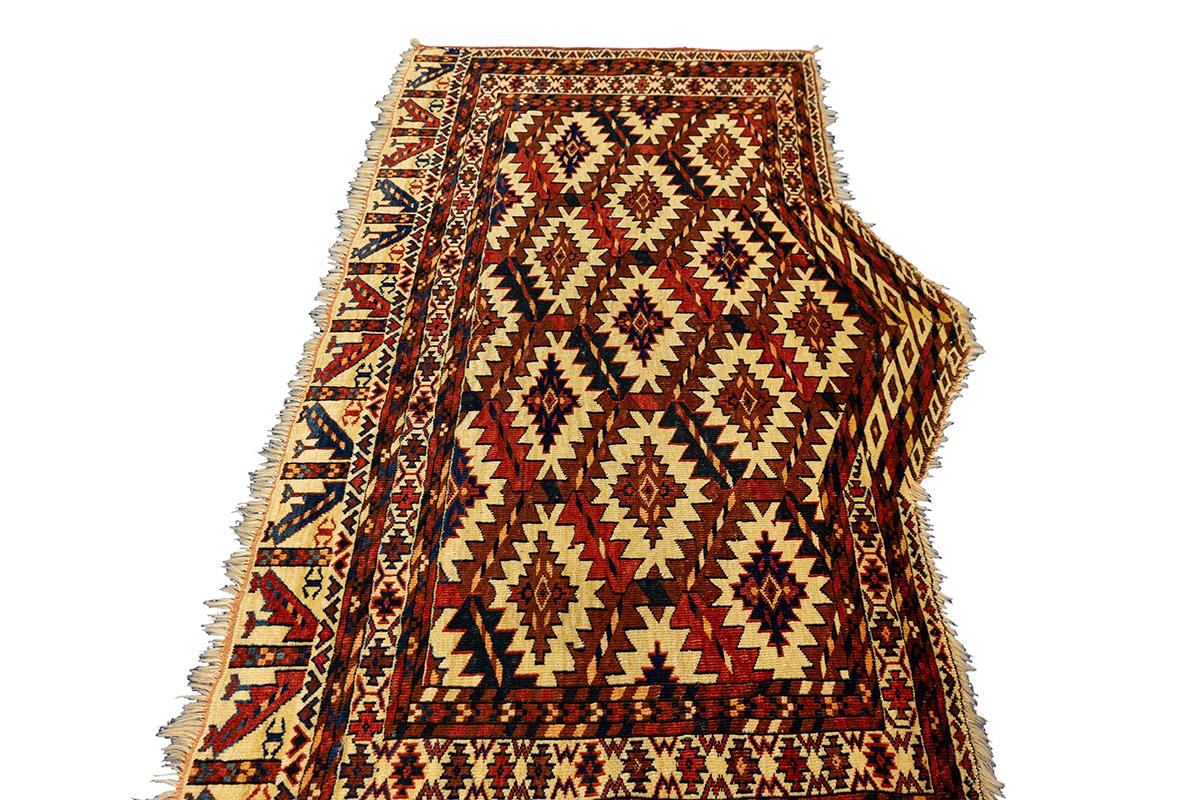 This rare Asmalik Yomut—a distinctive triangular piece used in Turkmen wedding processions—was woven by the Yomut (or Yomud) tribes of Central Asia. Asmaliks were typically created in pairs and draped over the flanks of the camel carrying the bride,