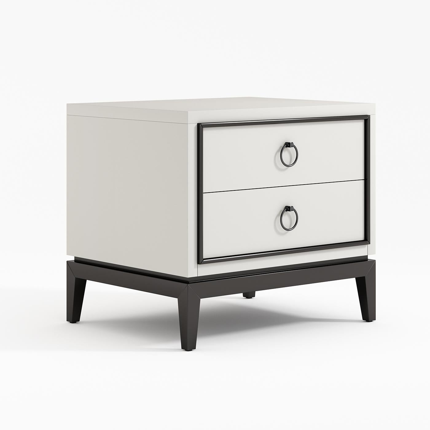This stunning nightstand is an ideal complement piece to the other Asmara White Furniture. Its wooden structure boasts a simple silhouette, highlighted by the used of two contrasting lacquers in black and white. The base and profiles are in solid