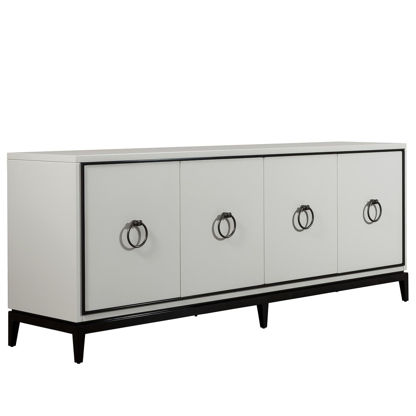 Timeless and sophisticated, this sideboard will add a bright decorative accent and precious storage space into a modern home. Its structure was crafted of wood with a visible base in solid wood that is also present in the profiles of the four doors.