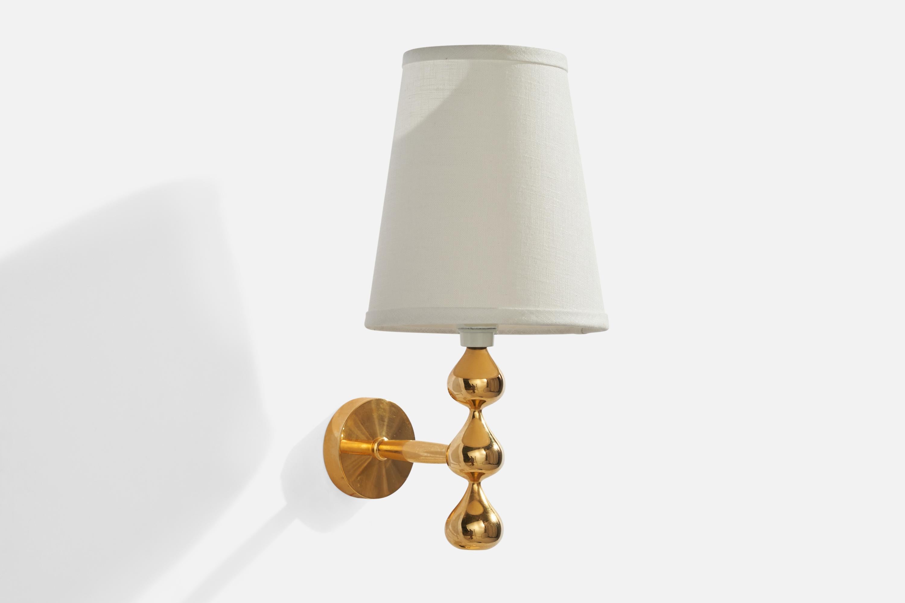 A gold-plated metal and white fabric wall light designed and produced by Asmussen Design, Denmark, c. 1980s.

Overall Dimensions (inches): 12.5” H x 6” W x 7.75” D
Back Plate Dimensions (inches): 2.75” H x 2.75” W x .75” D
Bulb Specifications: E-14