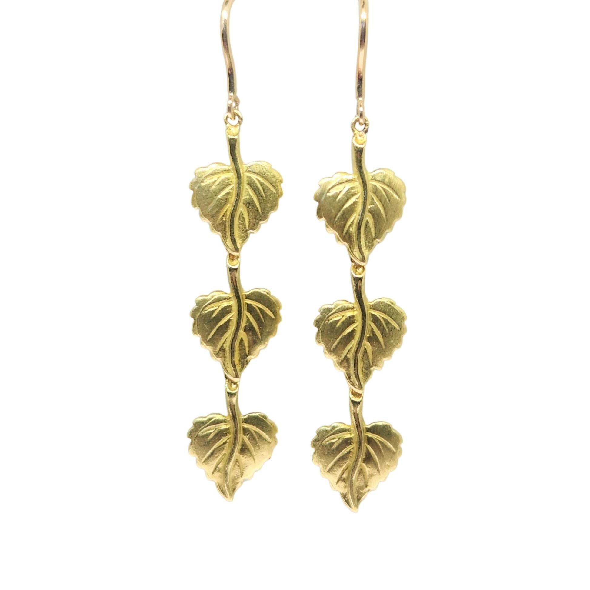 Warm 18K yellow gold drop earrings with 3 Aspen leaves that are linked for movement. Alison Nagasue incorporated her signature matte with polish finishing for a subtle natural and laid back look. The reverse side of the leaves has handmade texturing