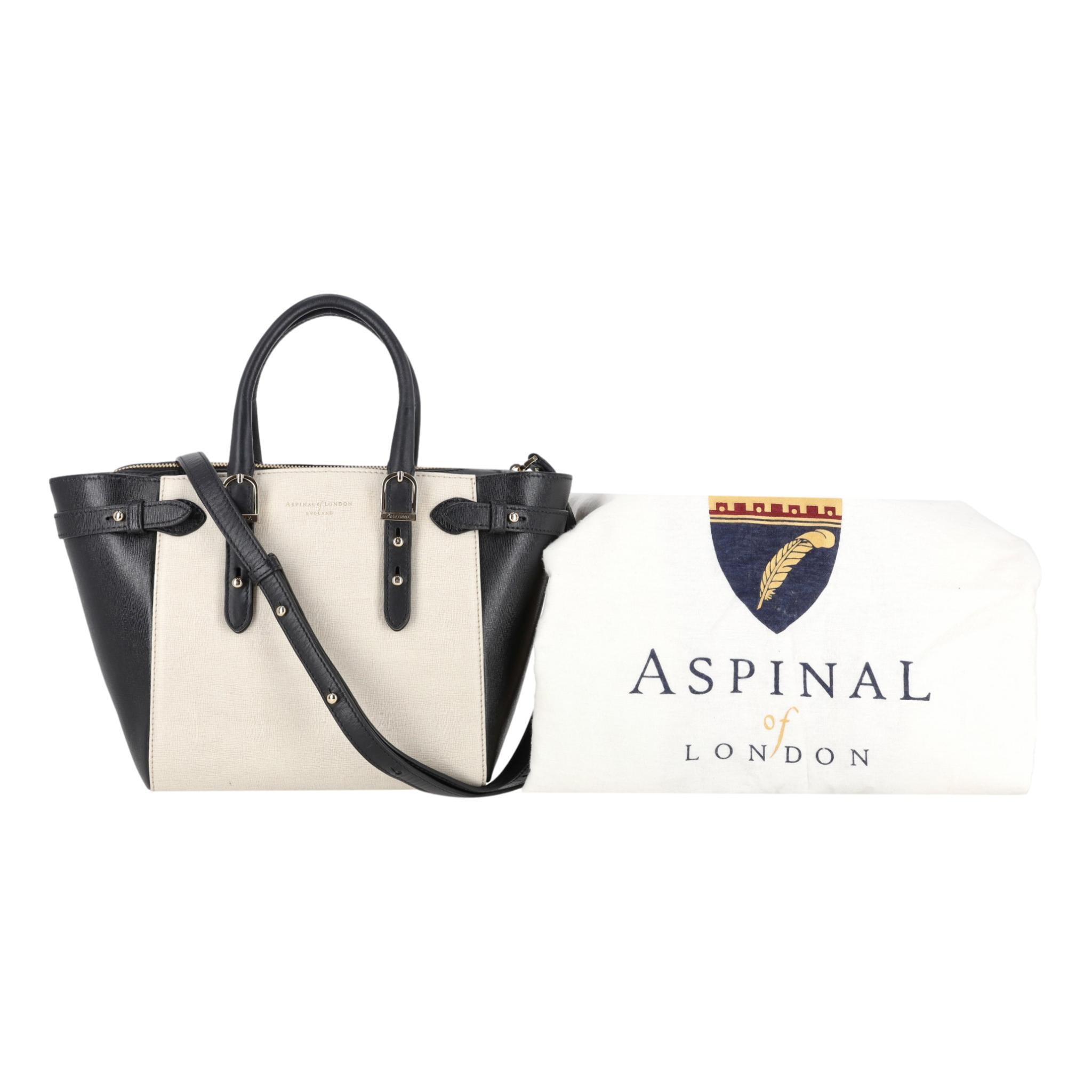 Aspinal Of London Mini Marylebone Leather Bag

Ivory tote bag with black sides and bottom handcrafted from Saffiano full-grained leather.

Detailed with branded gold hardware, dual top handle and detachable shoulder strap.

Featuring zipped top