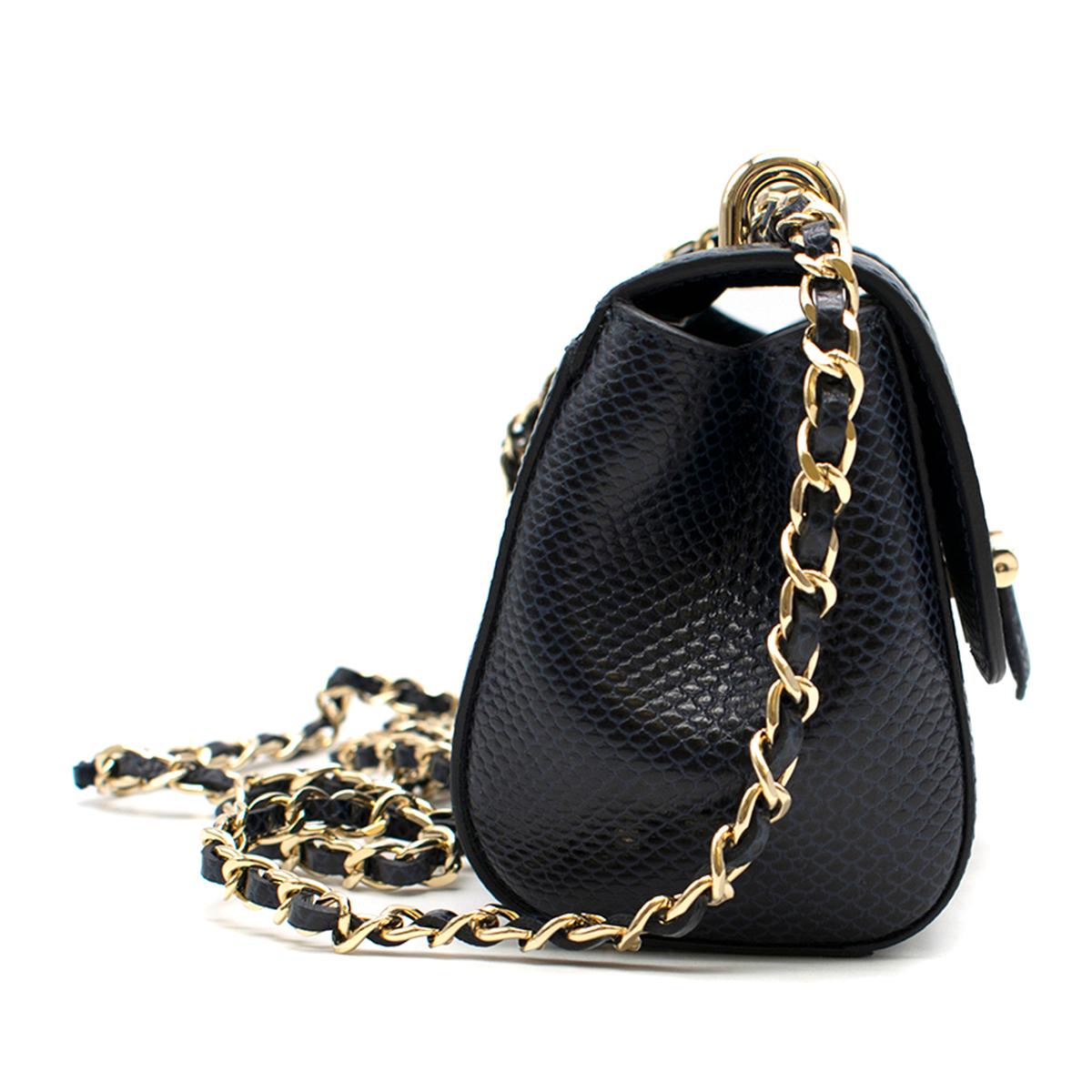 Aspinal of London Navy Reptile-effect Micro Lottie Bag

- Navy leather micro bag
- Reptile-effect leather
- Signature letterbox lock closure
- Leather plaited metal chain for shoulder and cross-body styling
- Grosgrain lined interior
- Interior