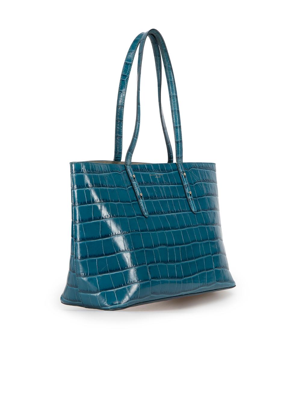 CONDITION is Good. General wear to tote is evident. Moderate discolouration to lining, small scuff marks to outer corners and creasing and light damage to handles on this used Aspinal of London designer resale item.



Details


Teal

Croc embossed