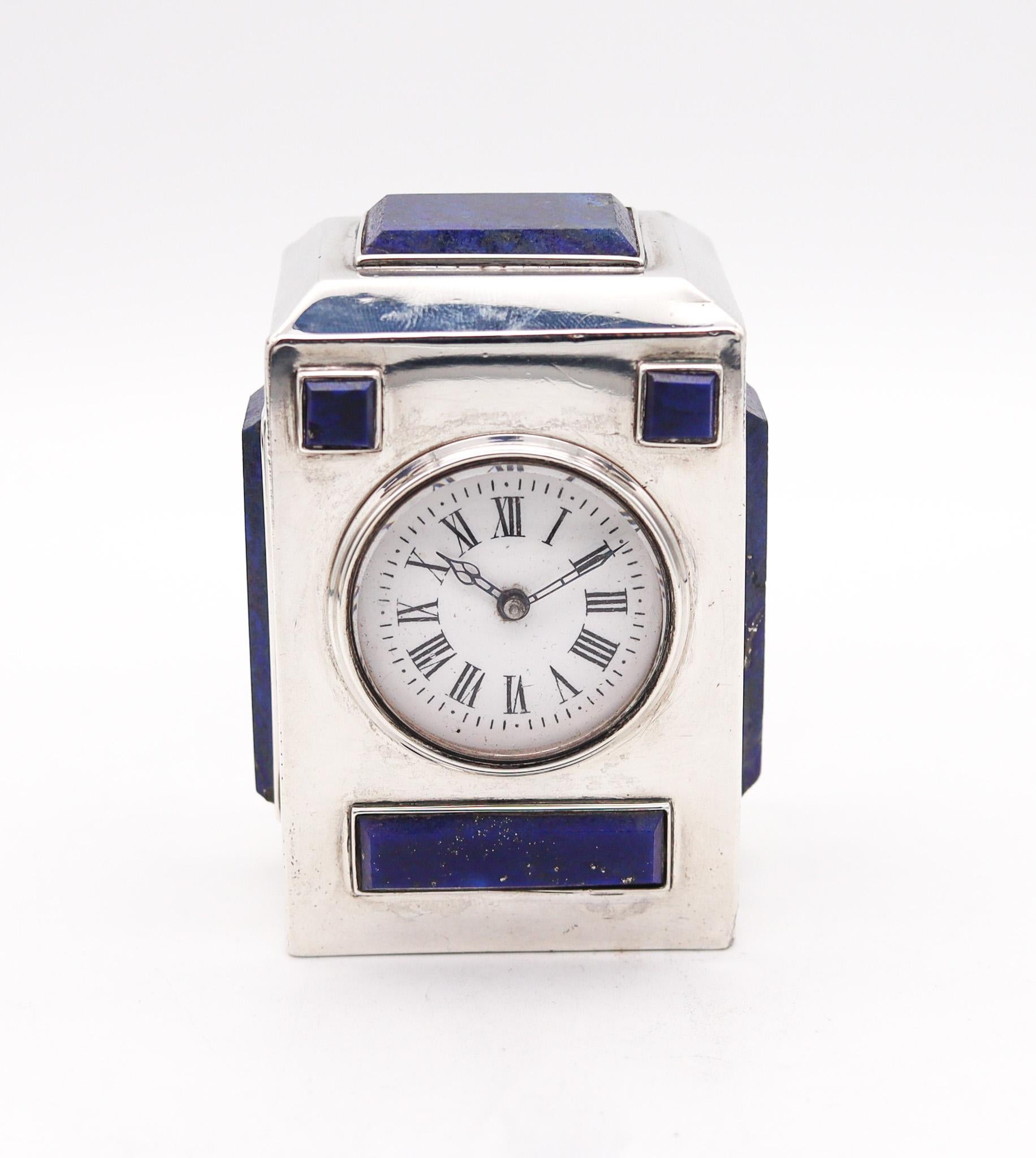 Desk clock designed by Asprey of London.

A gorgeous and imposing antique desk travel clock, created in London England by Charles & George Asprey in 1895. It was crafted with very unusual geometric patterns in very fine solid .925/.999 sterling