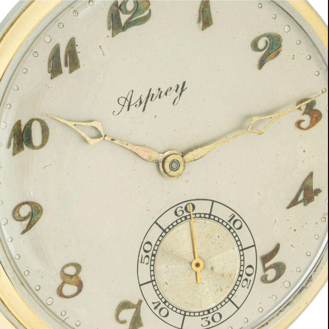 Asprey. AN 18ct Two Colour Gold Art Deco Keyless Lever Open Face Dress Pocket Watch C1920s

Dial: The silver satin finished dial signed Asprey, raised gold Arabic numerals and engine turned subsidiary seconds dial at six o'clock with original