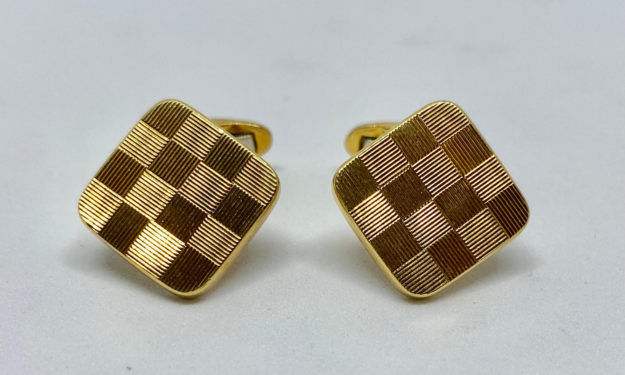 A classic checkerboard design beautifully rendered for Asprey in 18K yellow gold.

The cufflink faces measure 14.1mm square and feature oval-shaped toggle backs. The backs have a nice, firm snap to them. Together the cufflinks weigh just over 12