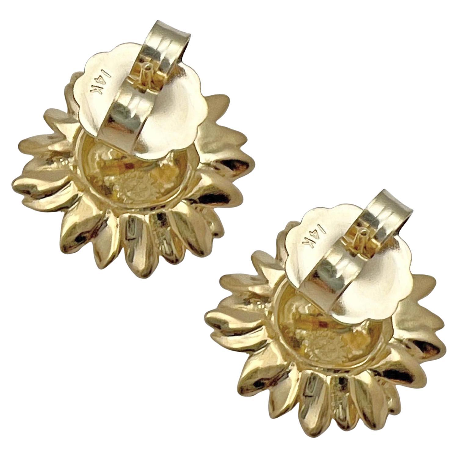 Asprey small sunflower stud earrings in textured and polished 18k yellow gold, displaying delicate petals radiating outwards from a raised center of seeds. The tips of the leaves curl slightly to give a real life-like appearance. Posts with