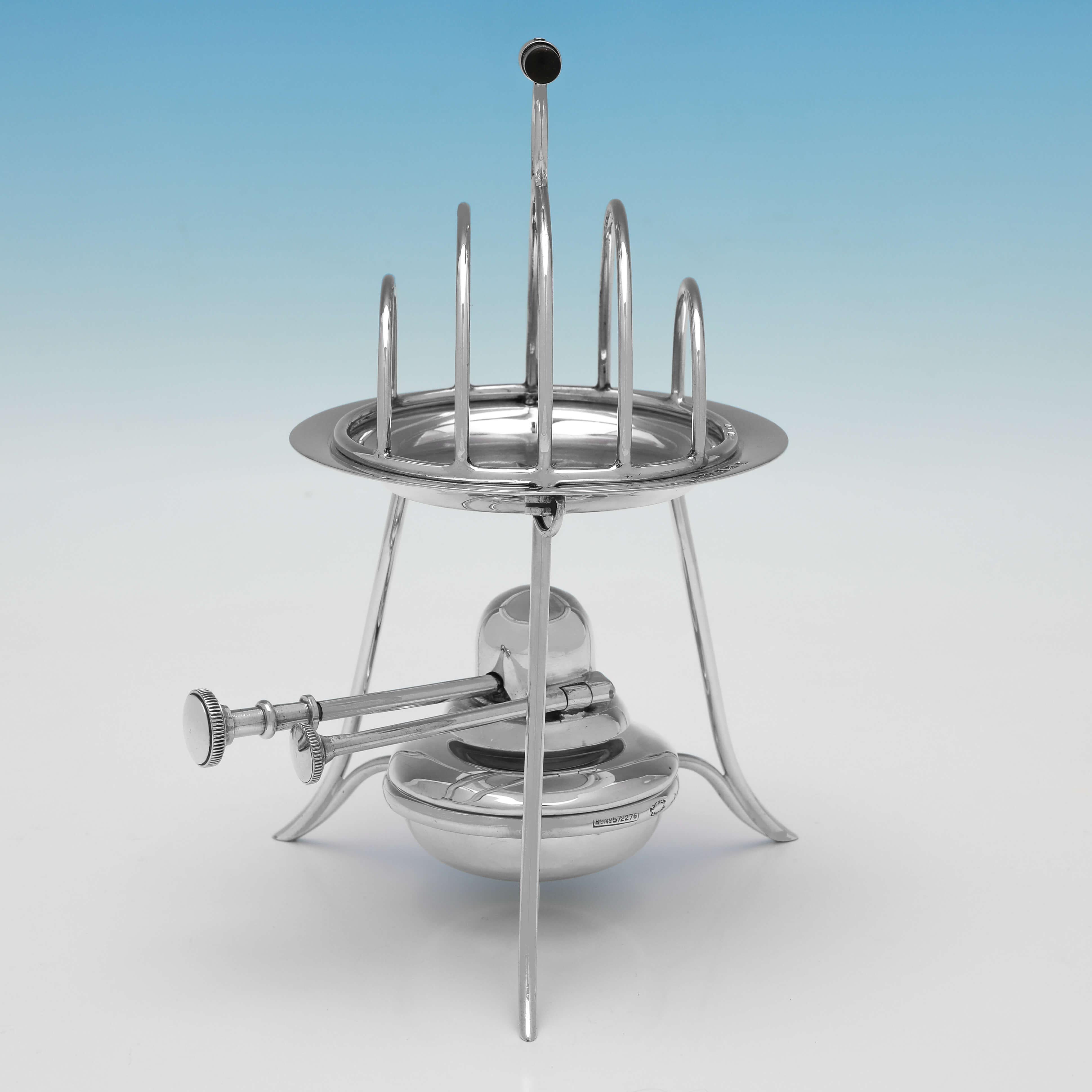 Hallmarked in Birmingham in 1912 by Asprey & Co. Ltd., this stylish, Antique Sterling Silver Toast Rack, will hold 4 slices of toast, and sits on top of a removable aluminium heater plate which sits above a spirit burner. 

The heated toast rack