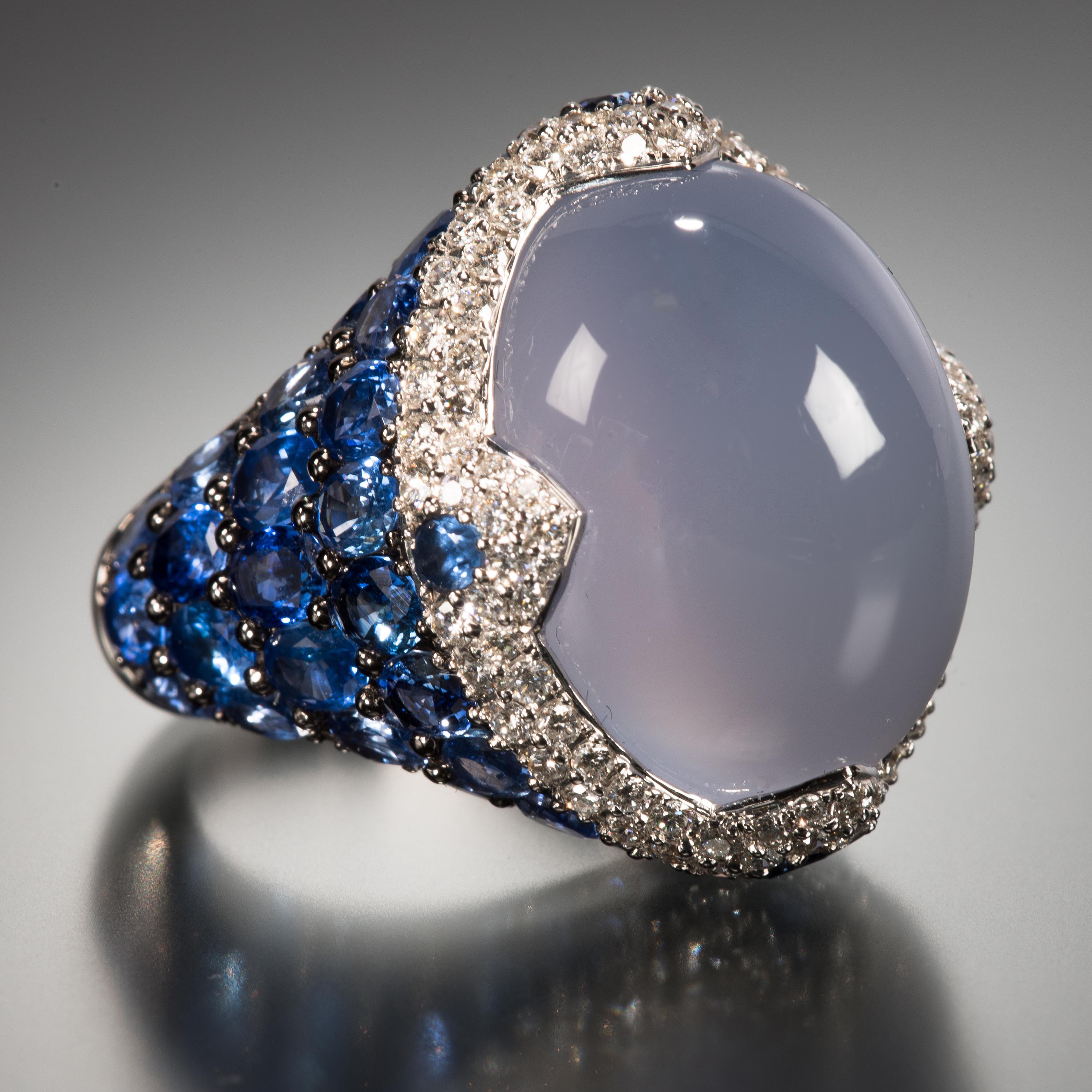Asprey demonstrates how stones can work together to create a piece that is truly exceptional. The center stone of this ring is a luscious 22.47 carat blue cabochon chalcedony surrounded by a collar of vibrant diamonds and enhanced by an exposed