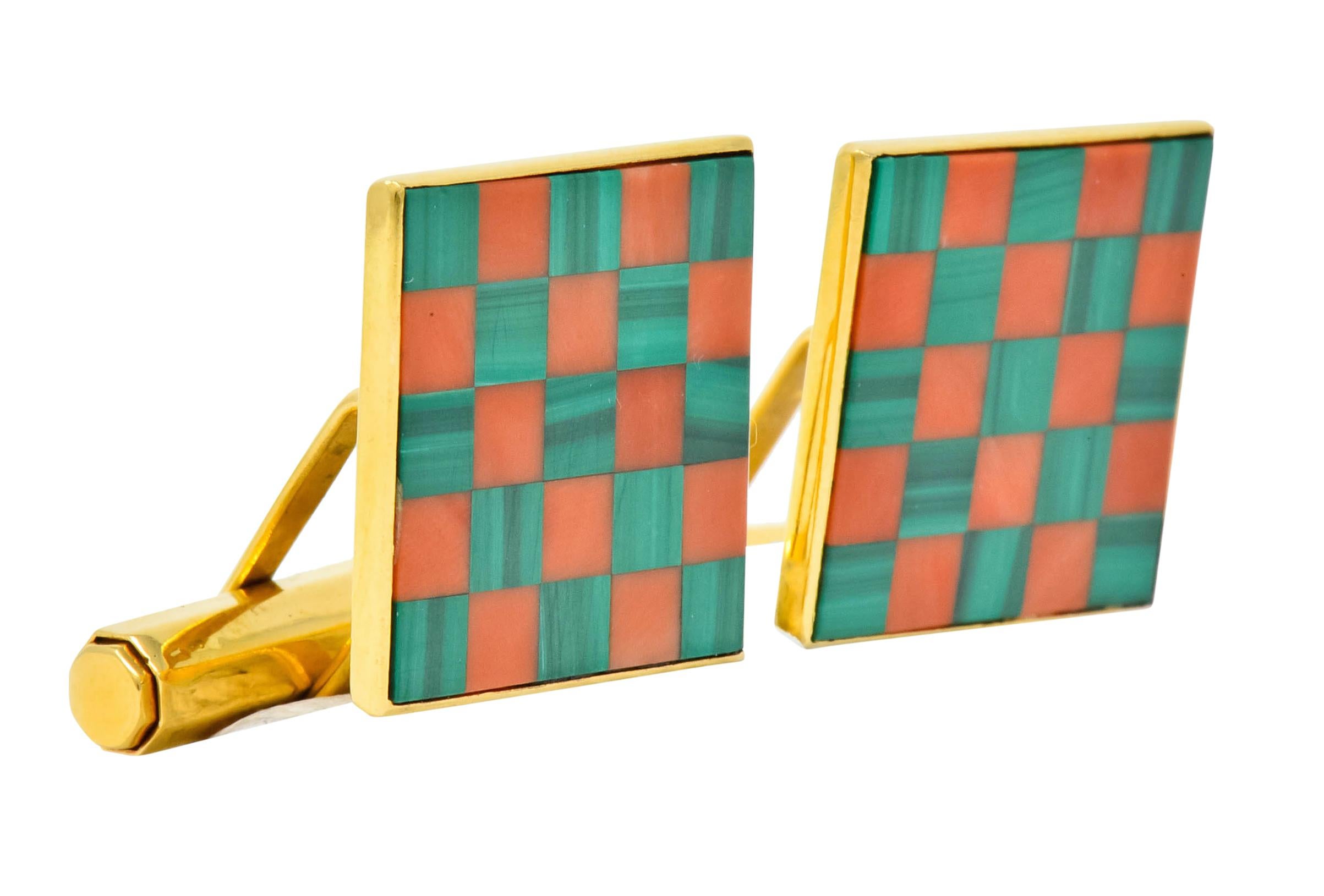 Lever style cufflinks featuring a large inlaid square in a polished gold surround

Inlay comprised of reddish-orange coral and banded green malachite, alternating seamlessly in a checkerboard motif

With maker's mark for Asprey & Co. and British