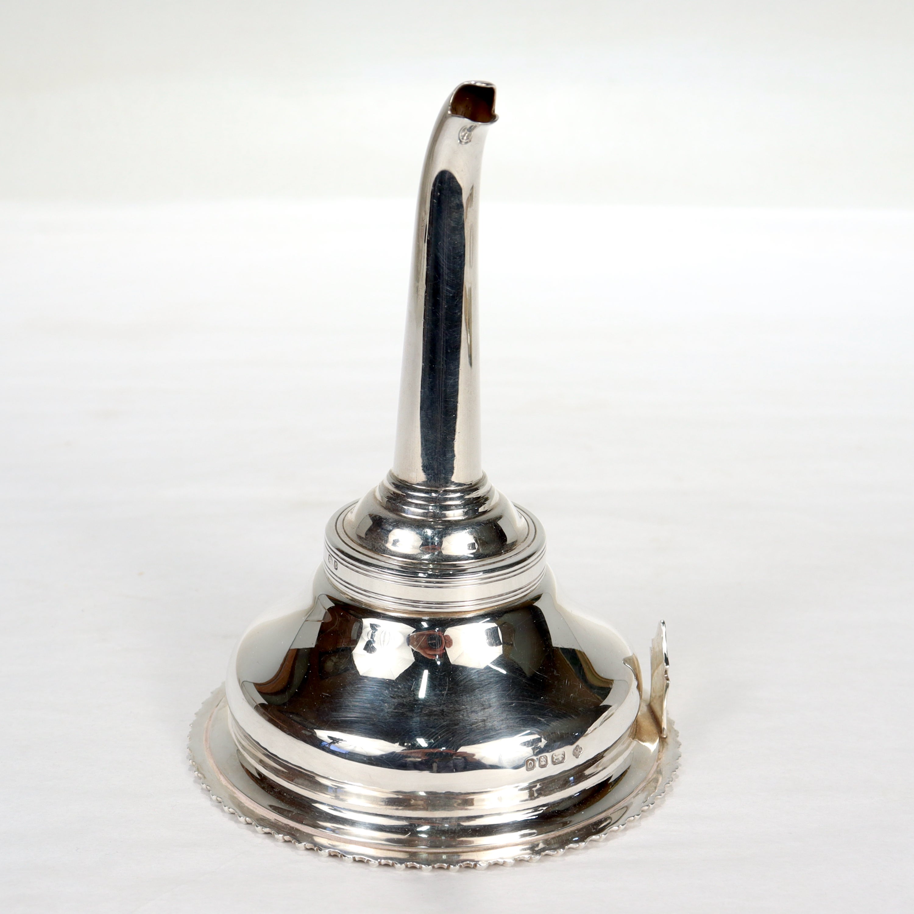 A fine English sterling silver wine funnel.
 
By Asprey & Co.

The funnel consists of three pieces - the funnel, the spout, and an interior ring that sits where the two connect.

Simply a great funnel from one of England's premier