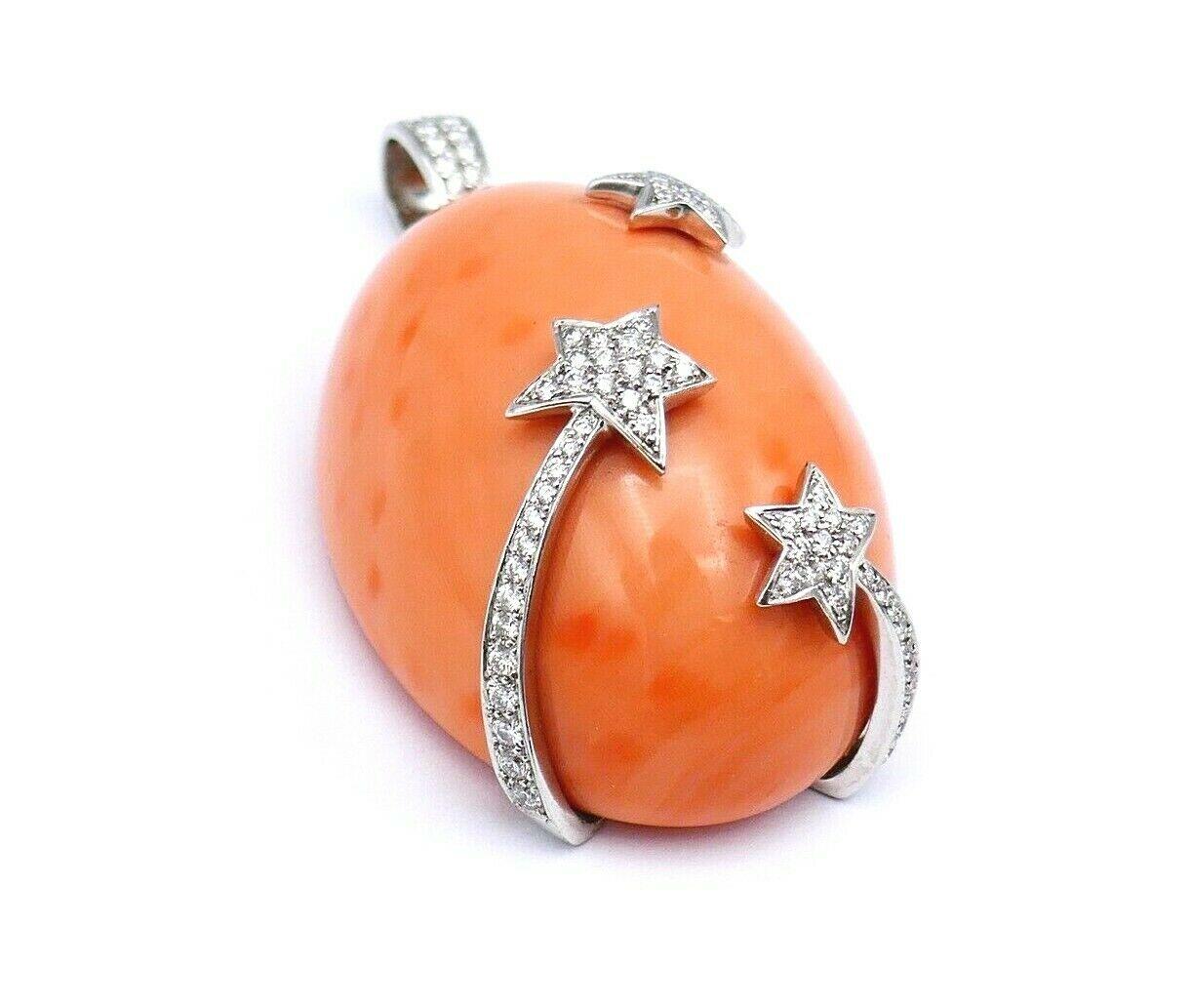 Beautiful chunky pendant with celestial motifs by Asprey. Made of coral and 18k white gold featuring 2.00 carats of brilliant cut diamond. 
Stamped with Asprey maker's marks and a hallmark for 18k gold. 
Measurements: 2,5