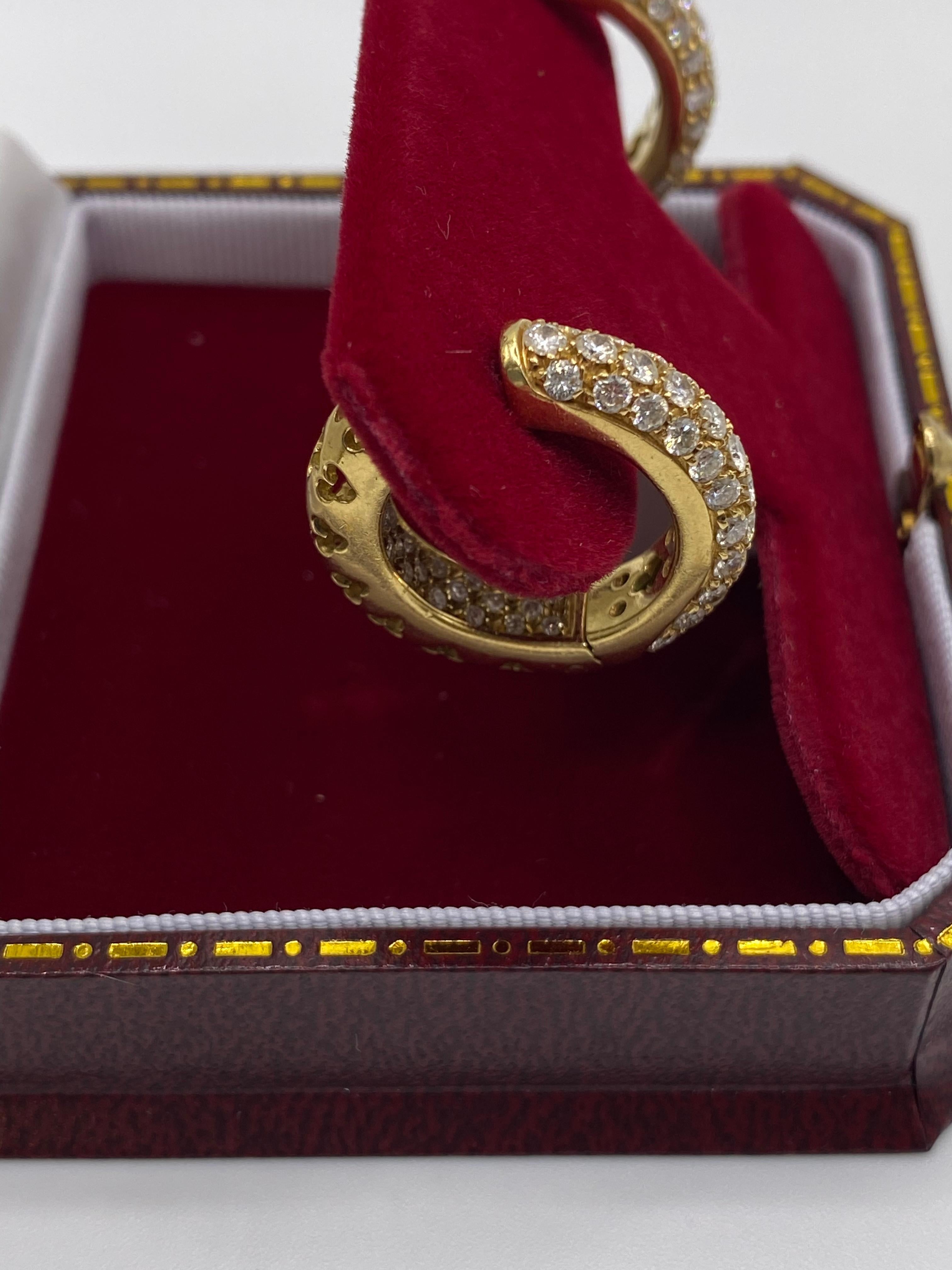 A pair of Asprey diamond earrings, each pave-set with brilliant-cut diamonds. The earrings have British hallmarks for 18carat gold, with a gross weight 16 grams, total diamond weight approximately 2.00 carats.