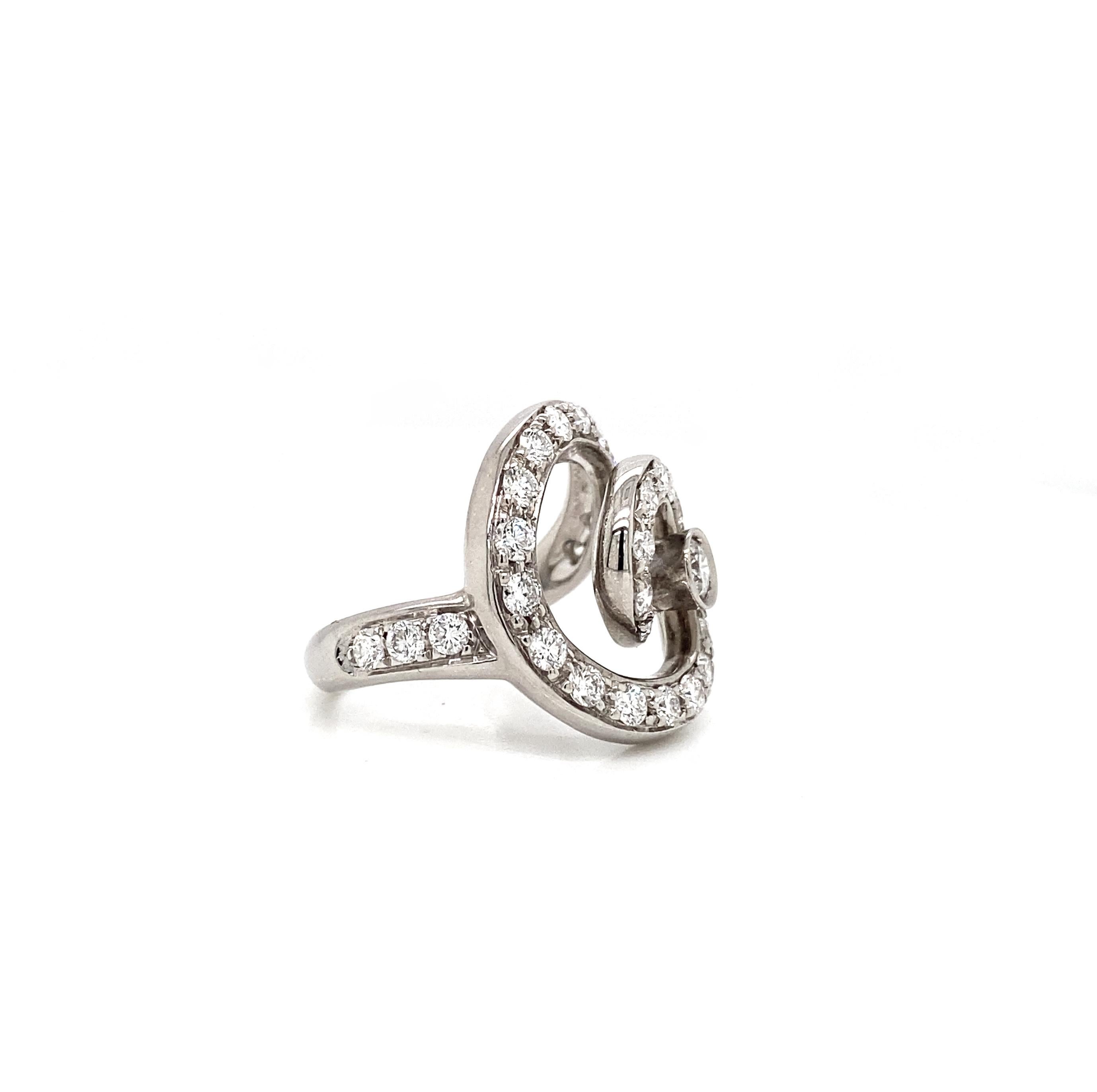 Delight yourself or someone you love with this gorgeous dress ring by Asprey, exquisitely crafted in luxurious 18 carat white gold.

The piece features a bold, intricate design consisting of an artistic, open work large swirl that merges perfectly