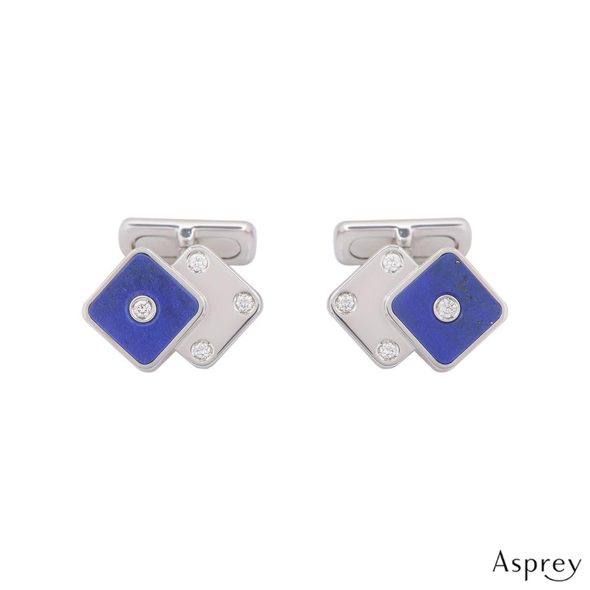 An 18k white gold pair of diamond and lapis cufflinks by Asprey. The cufflinks are in a design of two dice both set with round brilliant cut diamonds one with a lapis lazuli backing. The round brilliant cut diamonds have an approximate weight of