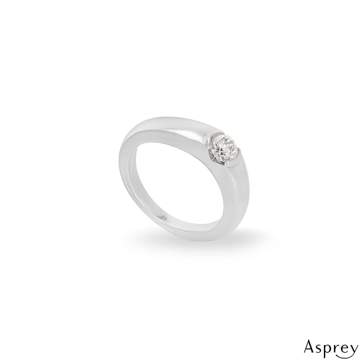 A stunning Asprey round brilliant cut diamond ring in platinum with matching wedding band. The rub over set round brilliant cut diamond weighs 0.32ct is H colour and VS1 clarity. The ring is currently a UK size G and US 3 3/8.

The plain 4mm