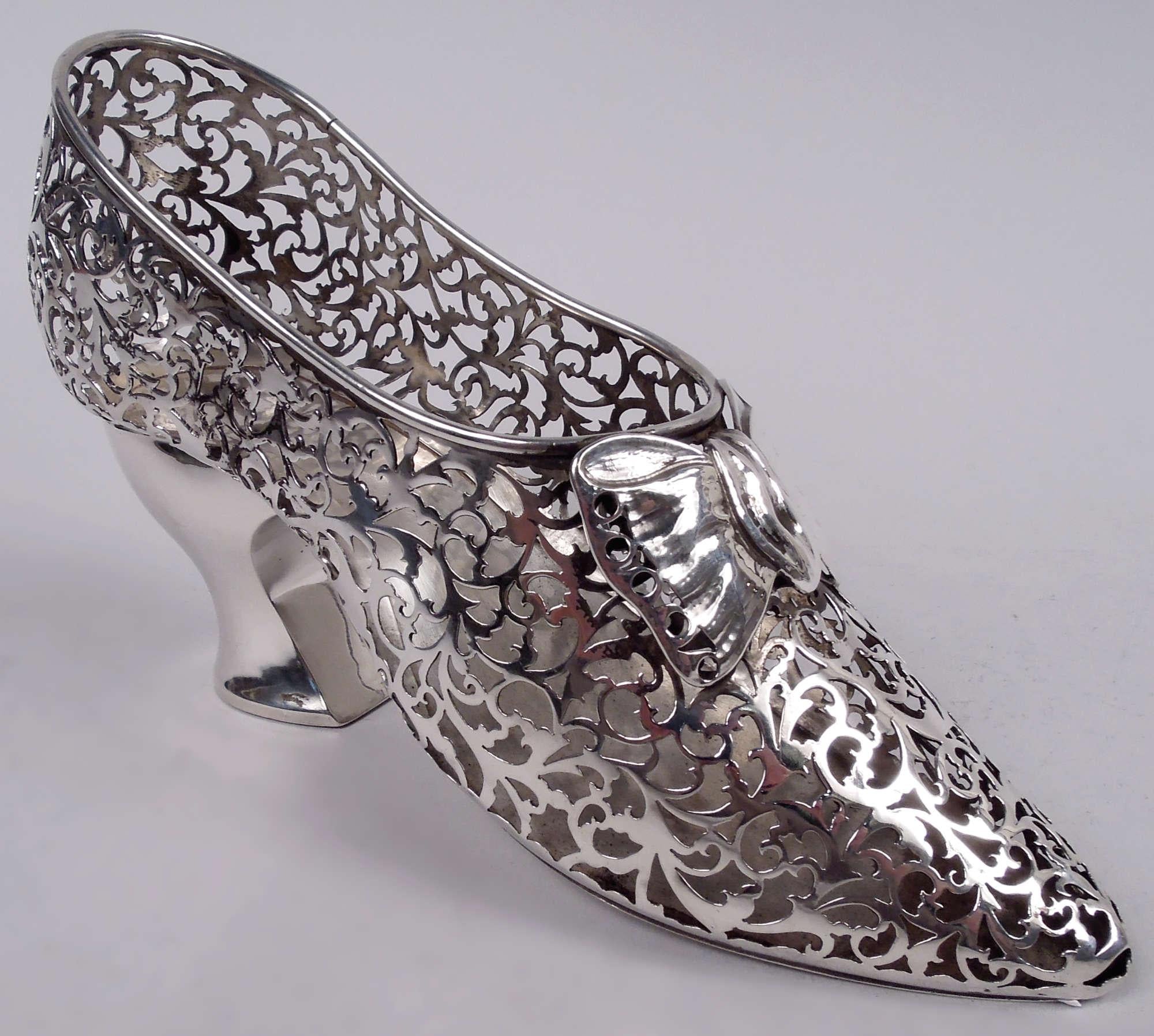 English Edwardian sterling silver lady’s shoe ornament, 1908. Open scrollwork and applied bow; pointed toe and solid high heel. Fully marked including maker’s (George Nathan & Ridley Hayes) and retailer’s (Asprey) stamps, and assay stamp (Chester).