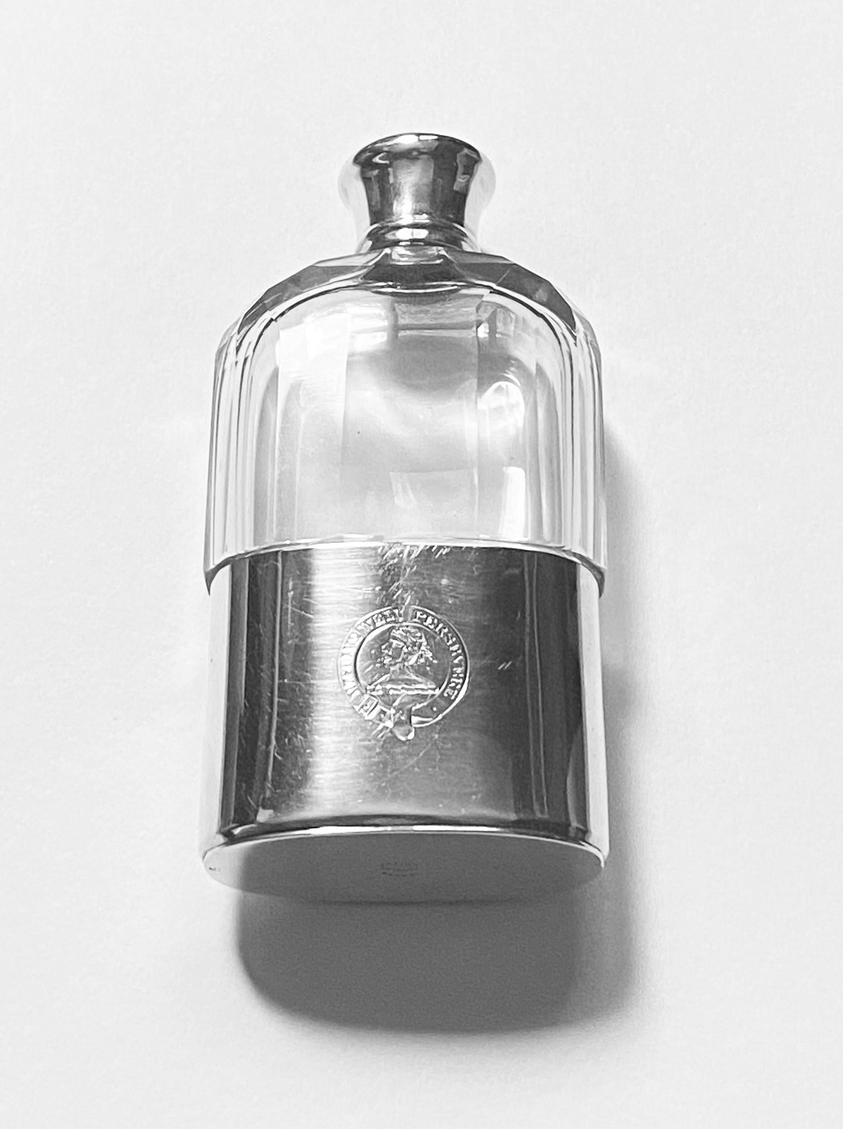 Asprey English hallmarked Silver hip flask, London 1867, Wright and Davies, retailed by Asprey. The flask with lower silver detachable cup, gilded interior, upper faceted panel glass, silver screw top. The cup and cover engraved with crest and motto