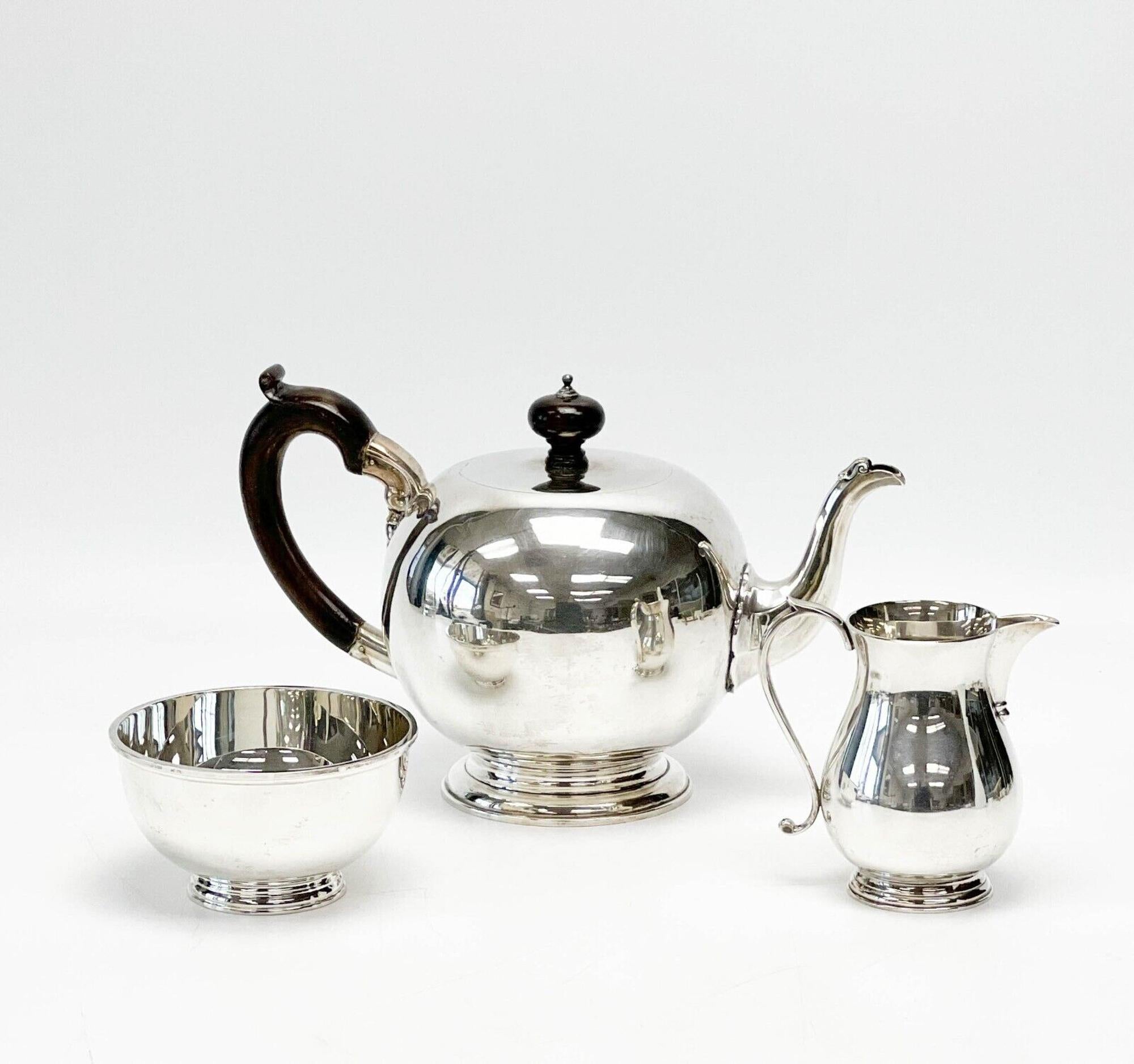 Asprey & Garrard England sterling silver tea set, 2000. Set includes teapot, creamer, and open sugar bowl. Teapot with wood handle and finial. Each with engraved monogram to the side. Asprey London hallmarks to the underside.

Additional