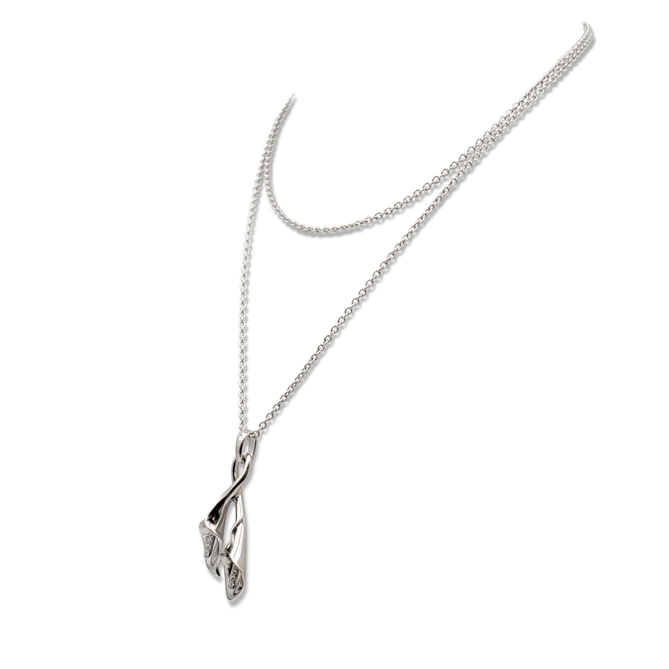 Authentic Asprey pendant designed as a double calla lily set with an estimated 0.25 carats of round brilliant cut diamonds. The pendant hangs from an oval-link chain. Signed Asprey, 750. Not presented with the original box or papers. CIRCA