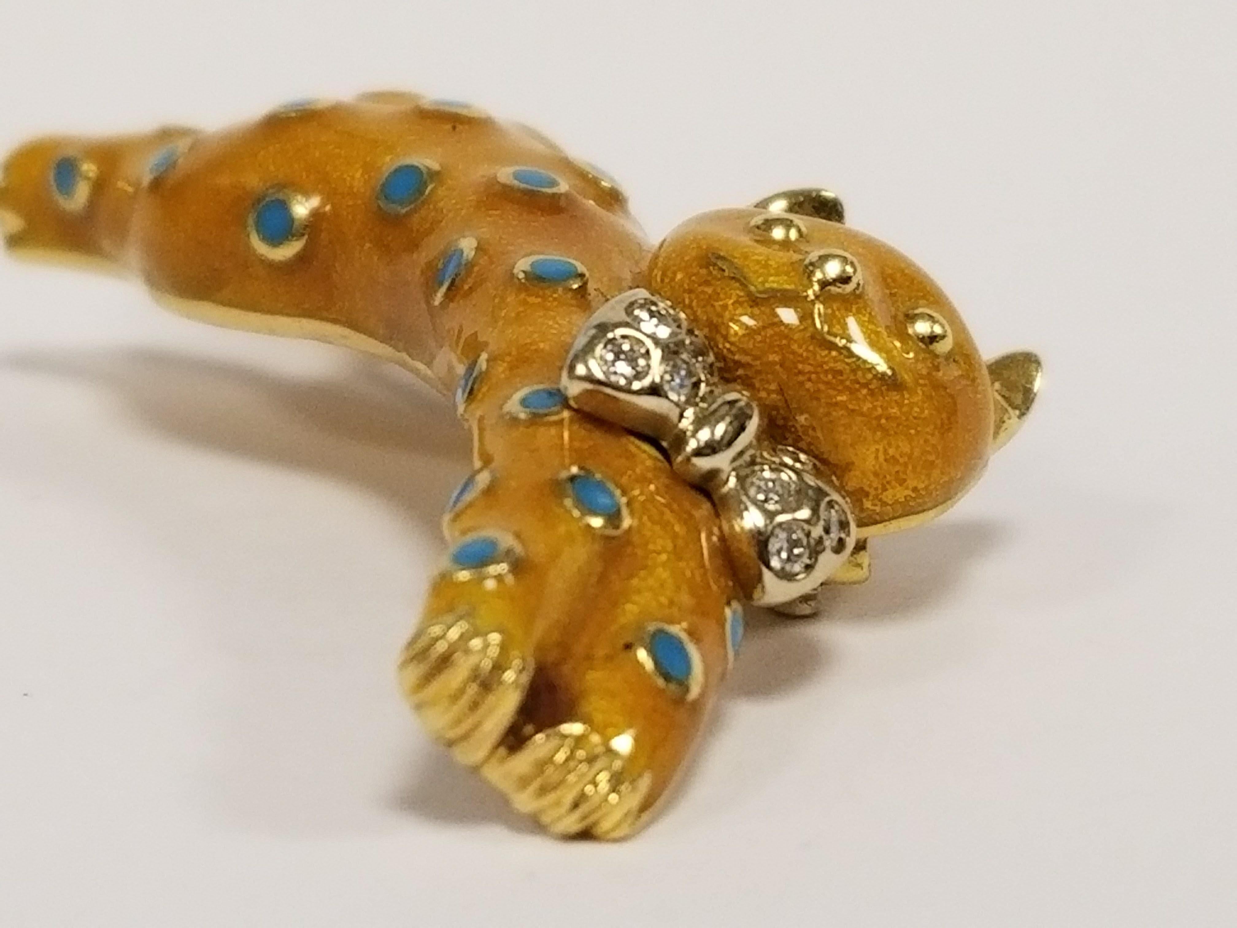 An Italian Estate 18 karat gold and enamel brooch with diamonds by Asprey London. The brooch has 10 round diamonds with an approximate total weight of .20 carats. The  golden enamel cat has sky blue enamel spots. Circa Estate.

Signed, 