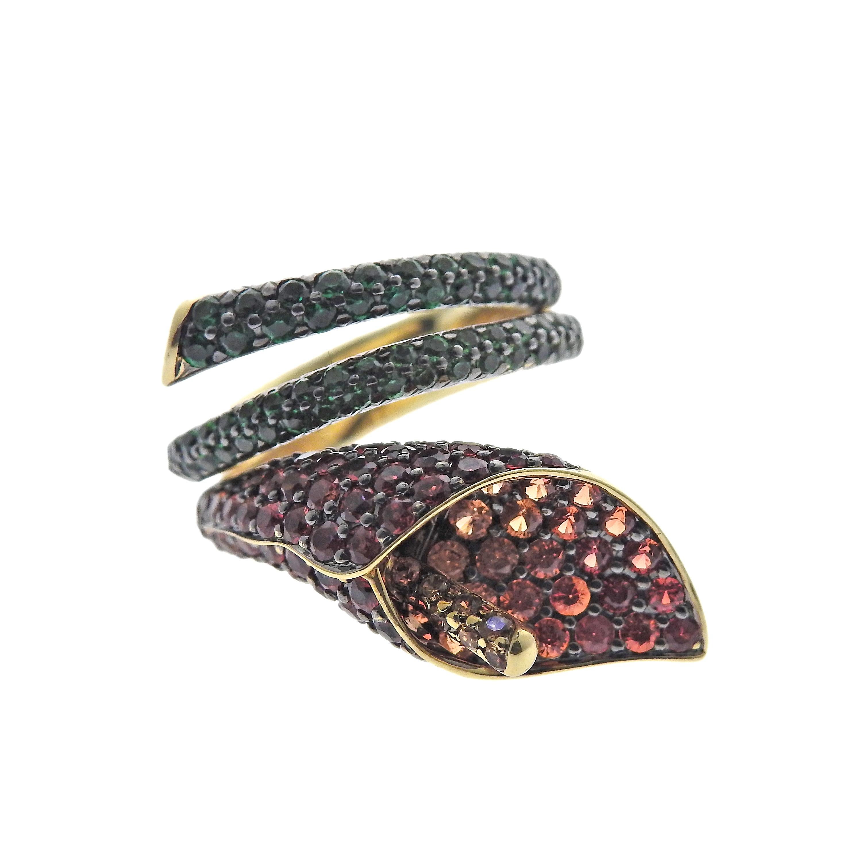 Asprey London Lily ring set in 18K yellow gold, with sapphires and tsavorites. Ring size is 5 1/2. Marked: Asprey, 750. Weight is 11.9 grams.