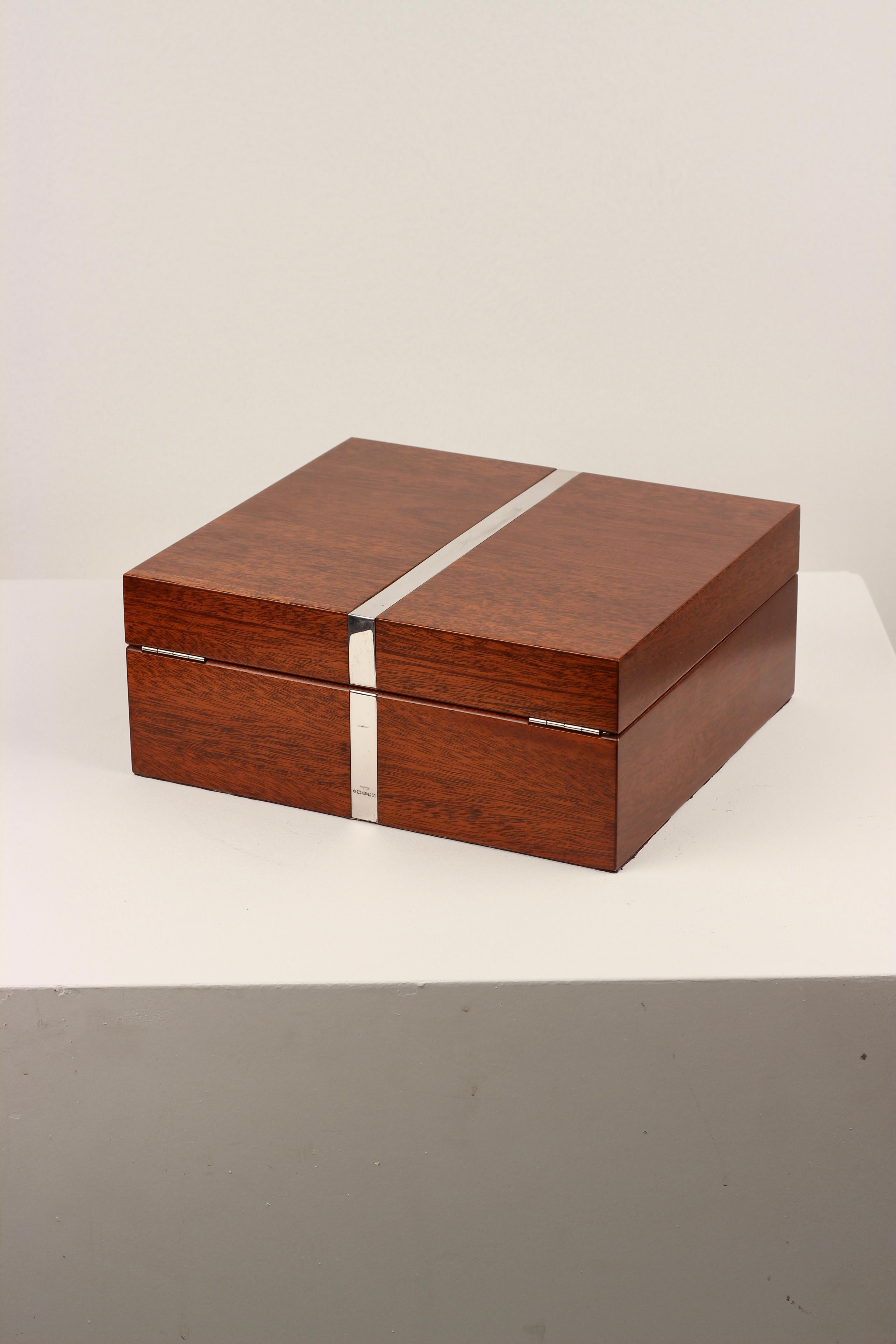Asprey London  Silver-Banded Rosewood Humidor with Hygrometer, c.1970s

This exceptional humidor by Asprey London showcases the brand’s renowned commitment to craftsmanship and understated luxury. Crafted in rich, finely grained wood, it is accented