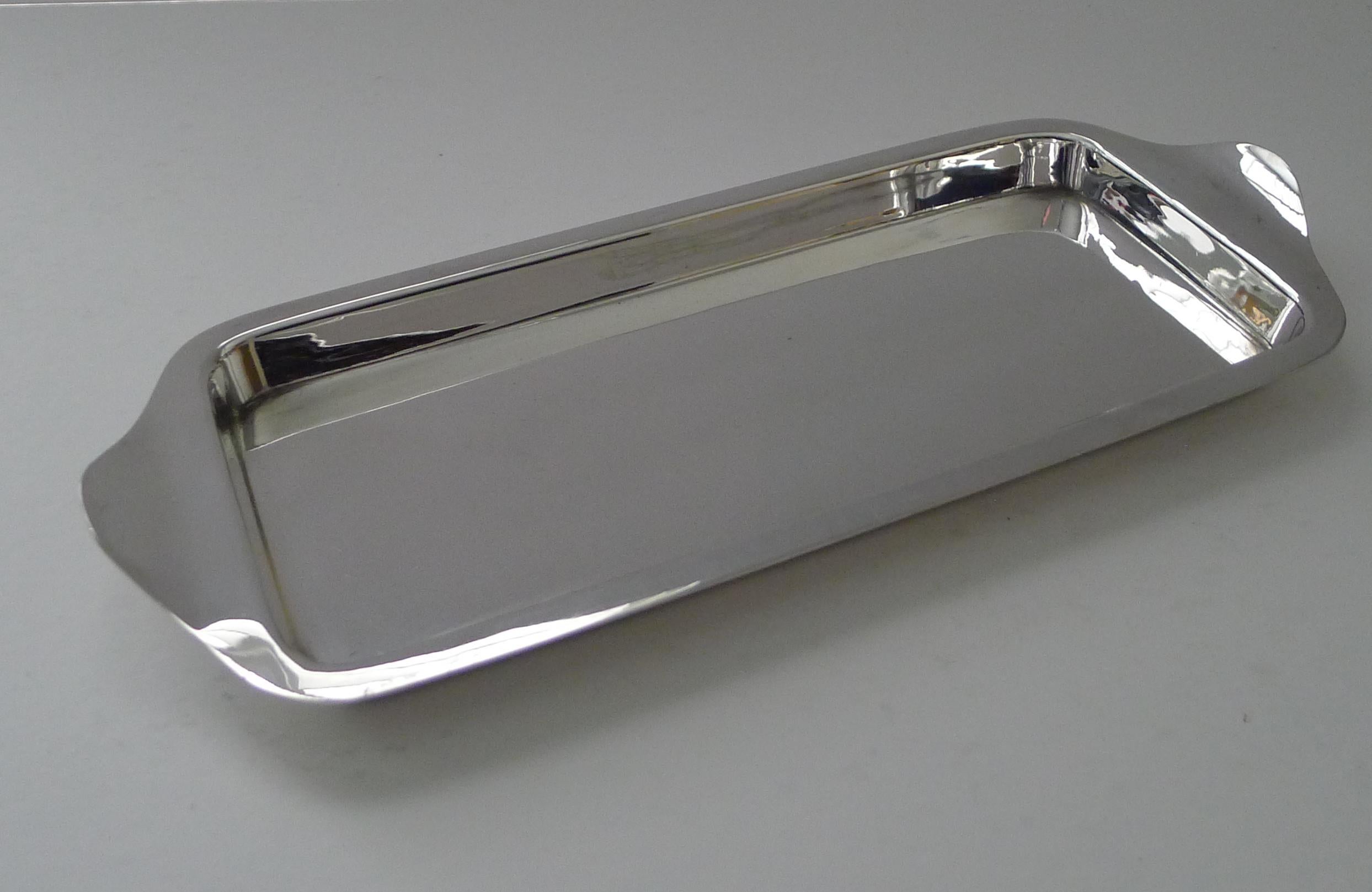 A handsome antique silver plated rectangular serving tray, perfect for a couple of glasses or to serve cocktail hors d'oeuvres or even finger sandwiches for afternoon tea.

Just back from our silversmith's workshop where it has been professionally