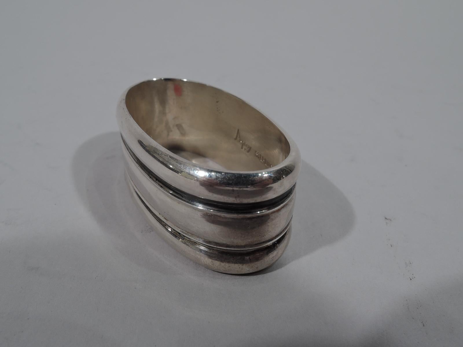 Midcentury Modern sterling silver napkin ring. Oval and lobed with tooled wraparound lines. Nice heft. Marked “Asprey Sterling”. Weight: 1.8 troy ounces.