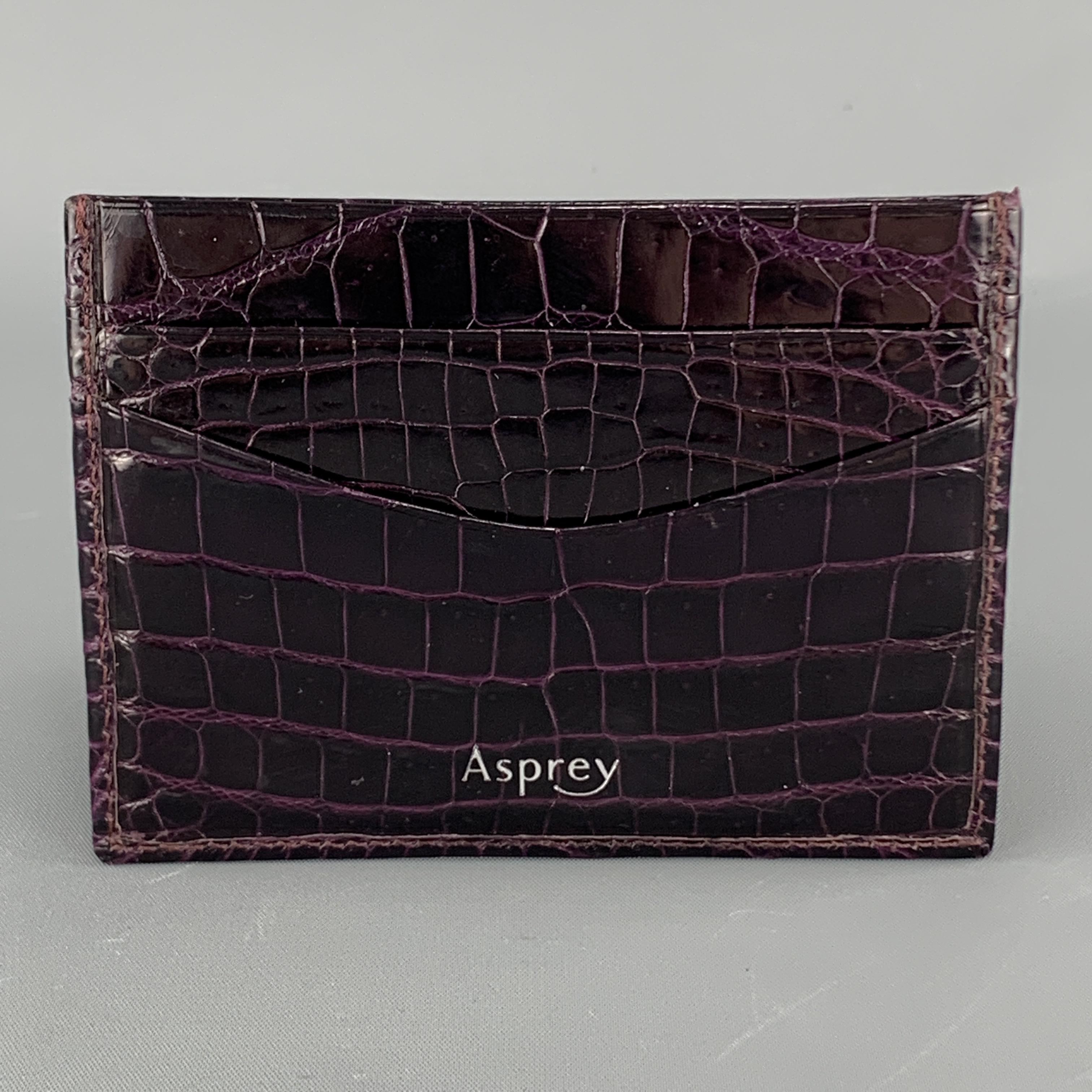ASPREY card case comes in rich eggplant purple alligator embossed patent leather with inner and outter card slots. 

Excellent Pre-Owned Condition.
4.5 x 3.25 in. 