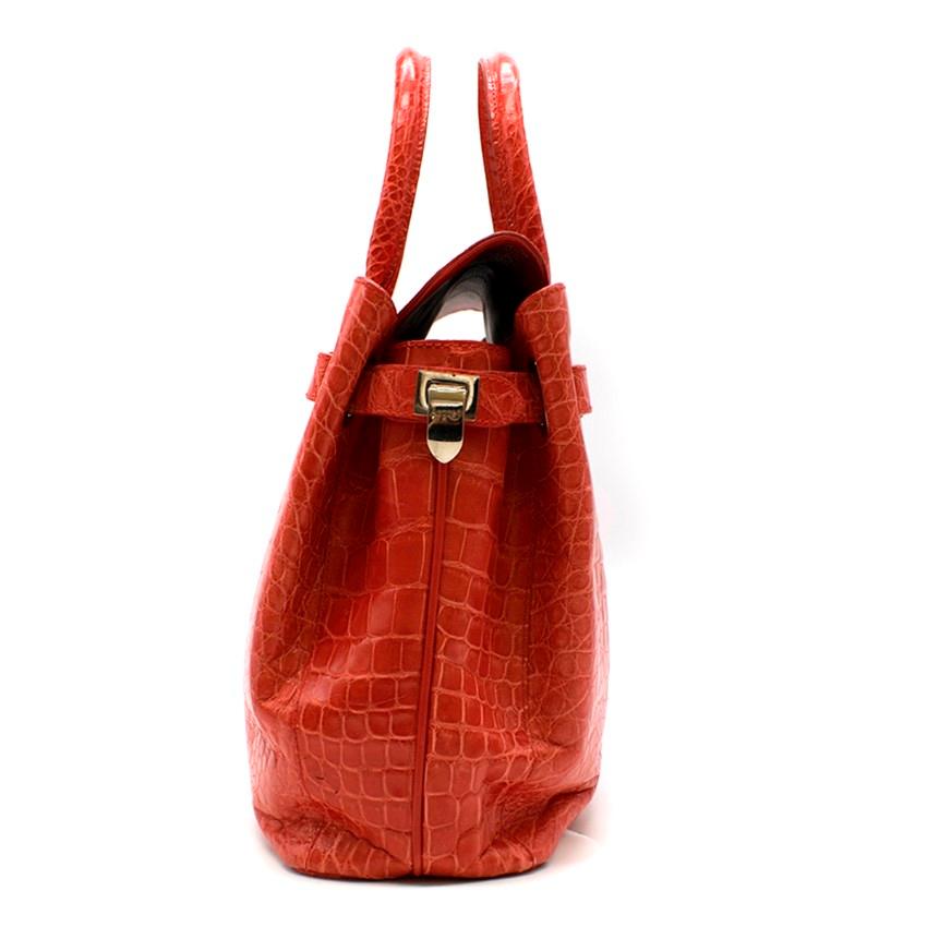 Asprey Red Darcy 30cm Silk Finish Crocodile Handbag

- Semi structured crocodile top-handle handbag 
- Tubular handles
- Signature Asprey clasps on side straps
- Two interior compartments with a push-buttoned top flap
- One interior zip pocket
- One