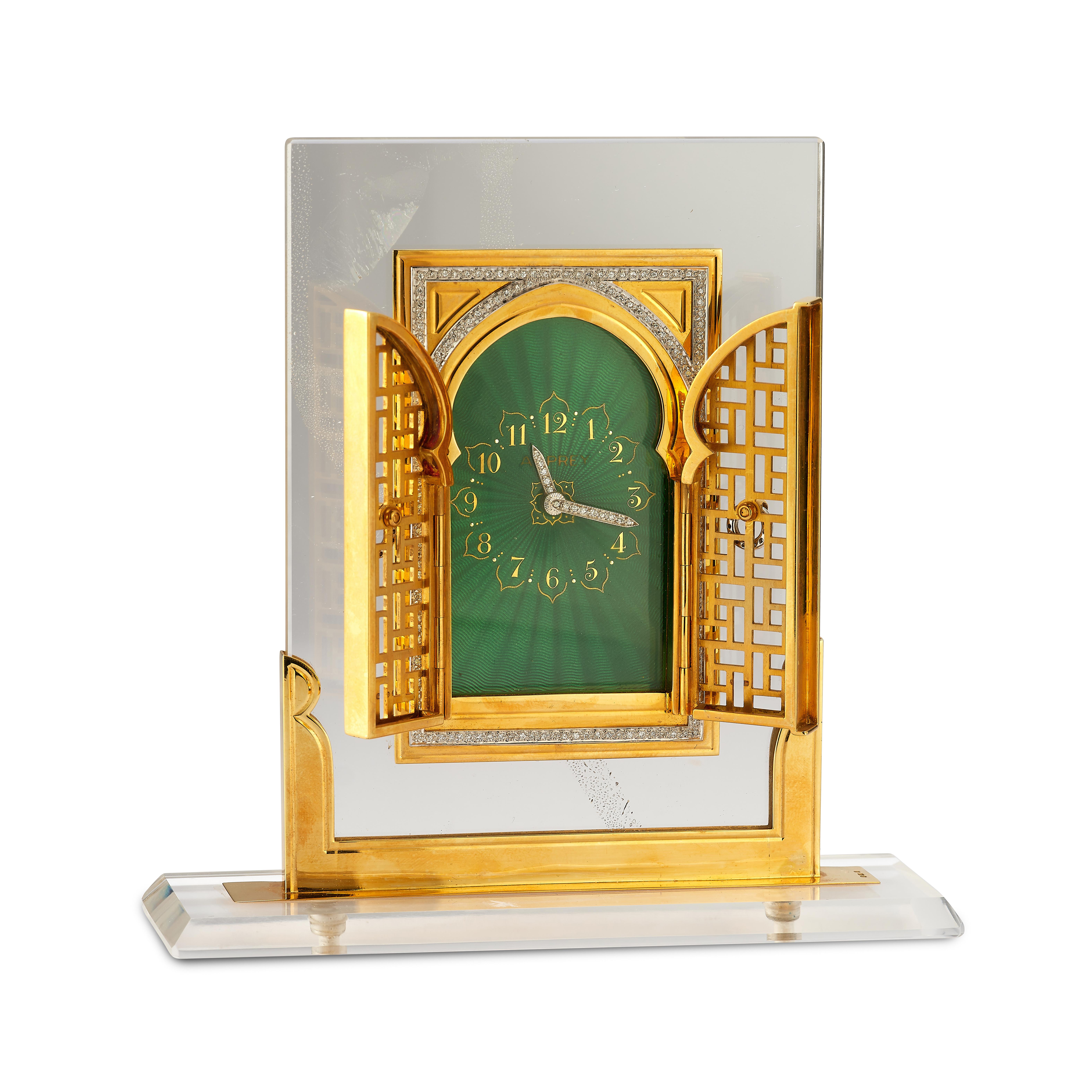 Asprey Rock Crystal Diamond & Enamel Desk Clock

A beautifully crafted desk clock with a rock crystal base, an 18-karat gold casing and framing embellished with diamonds, and a green guilloche enamel face

Signed Asprey London

Mechanical movement