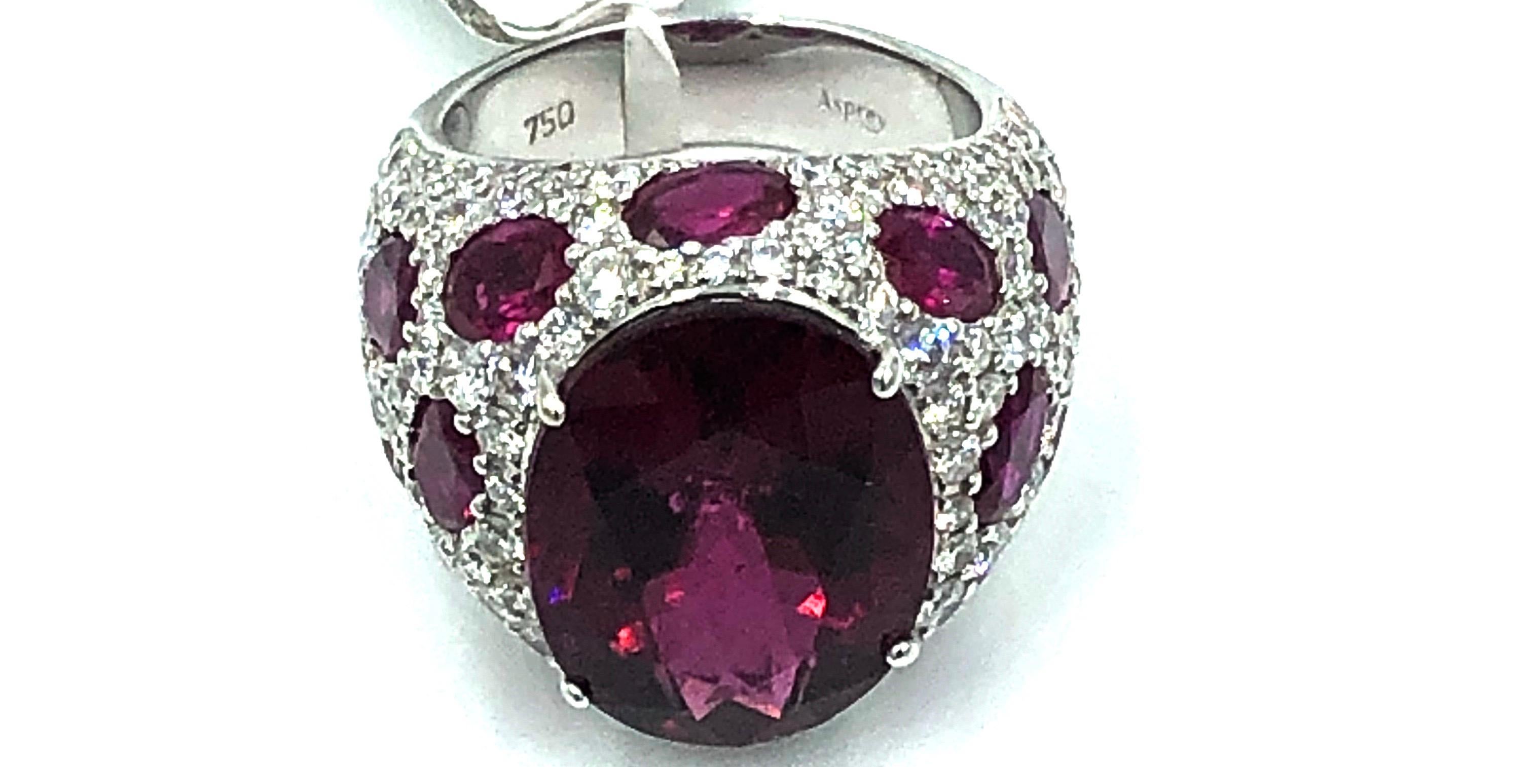 The colors in this beautifully crafted ring From Asprey of London are intense and captivating.
The mounting for the 12.82 ct Rubellite consists of 3.18 carats of pave diamonds and  7.19 carats of stunning red rubies. Elegant, beautiful and timeless,