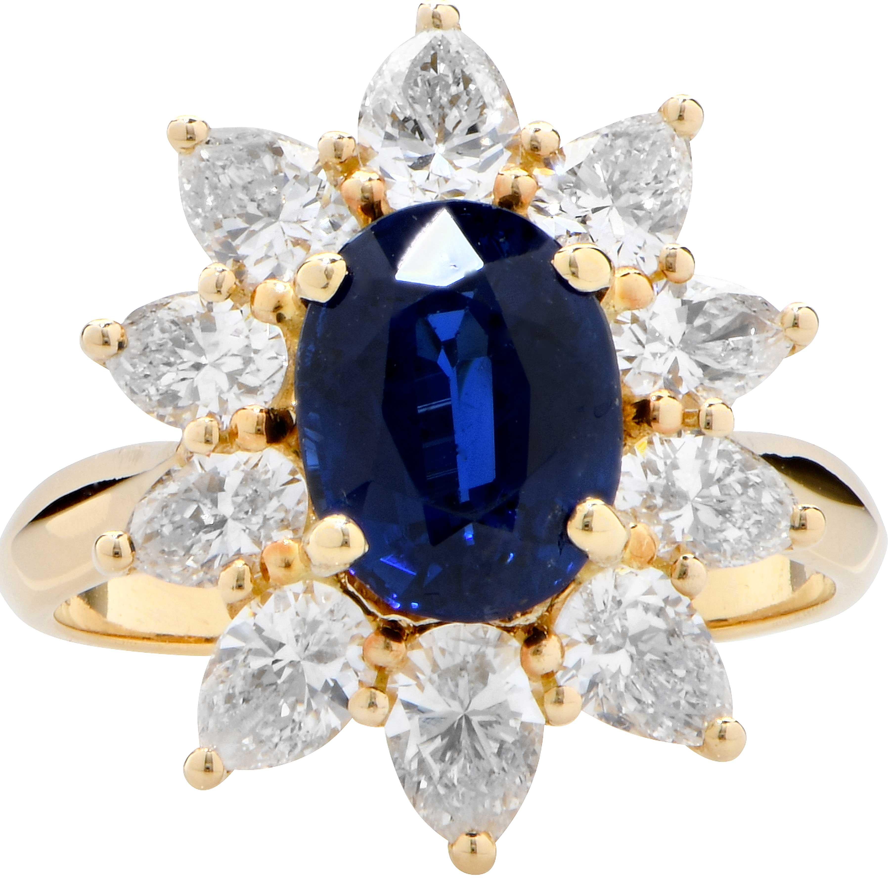 This beautiful sapphire and diamond ring was manufactured by Asprey of London, Jewelers to the Queen. The ring features an oval cut blue sapphire with an approximate weight of 2.30 carats surrounded by 10 pear shape diamonds with an approximate