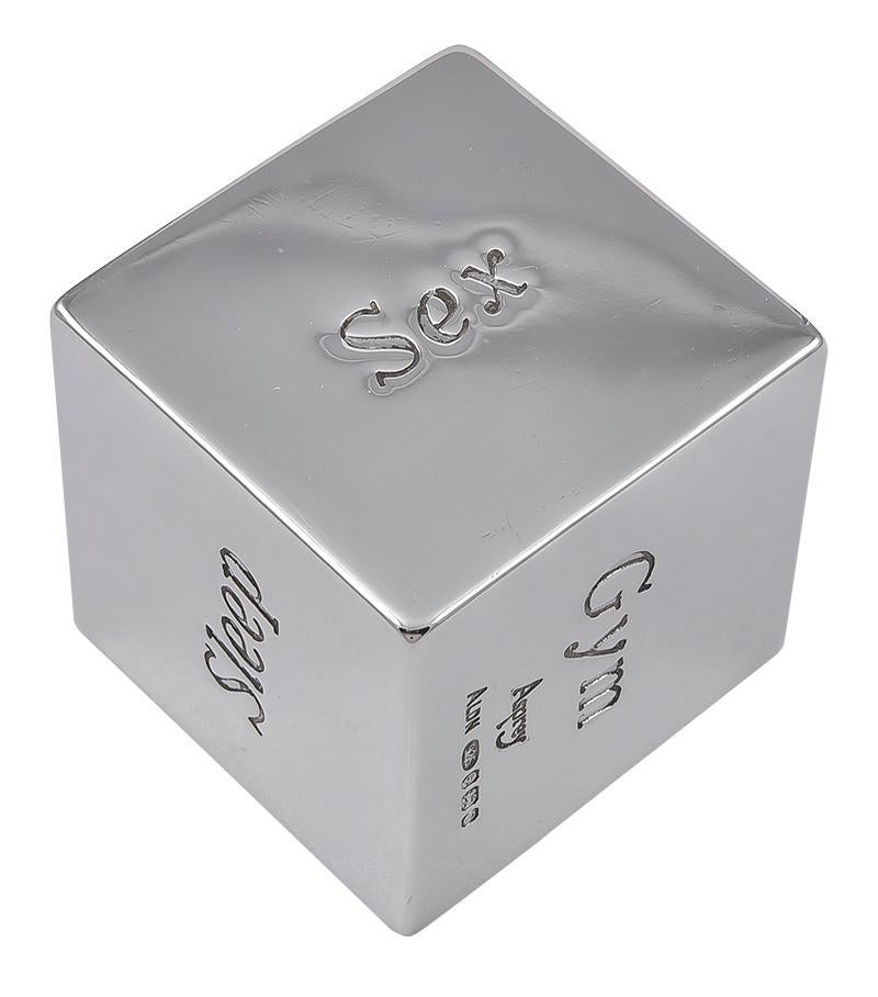 Sterling silver cube.  Made and signed by ASPREY.  Each side is engraved with a favorite activity/hobby:  Sports, Cinema, Sleep, Sex, Gym, Drinks.  1 1/4