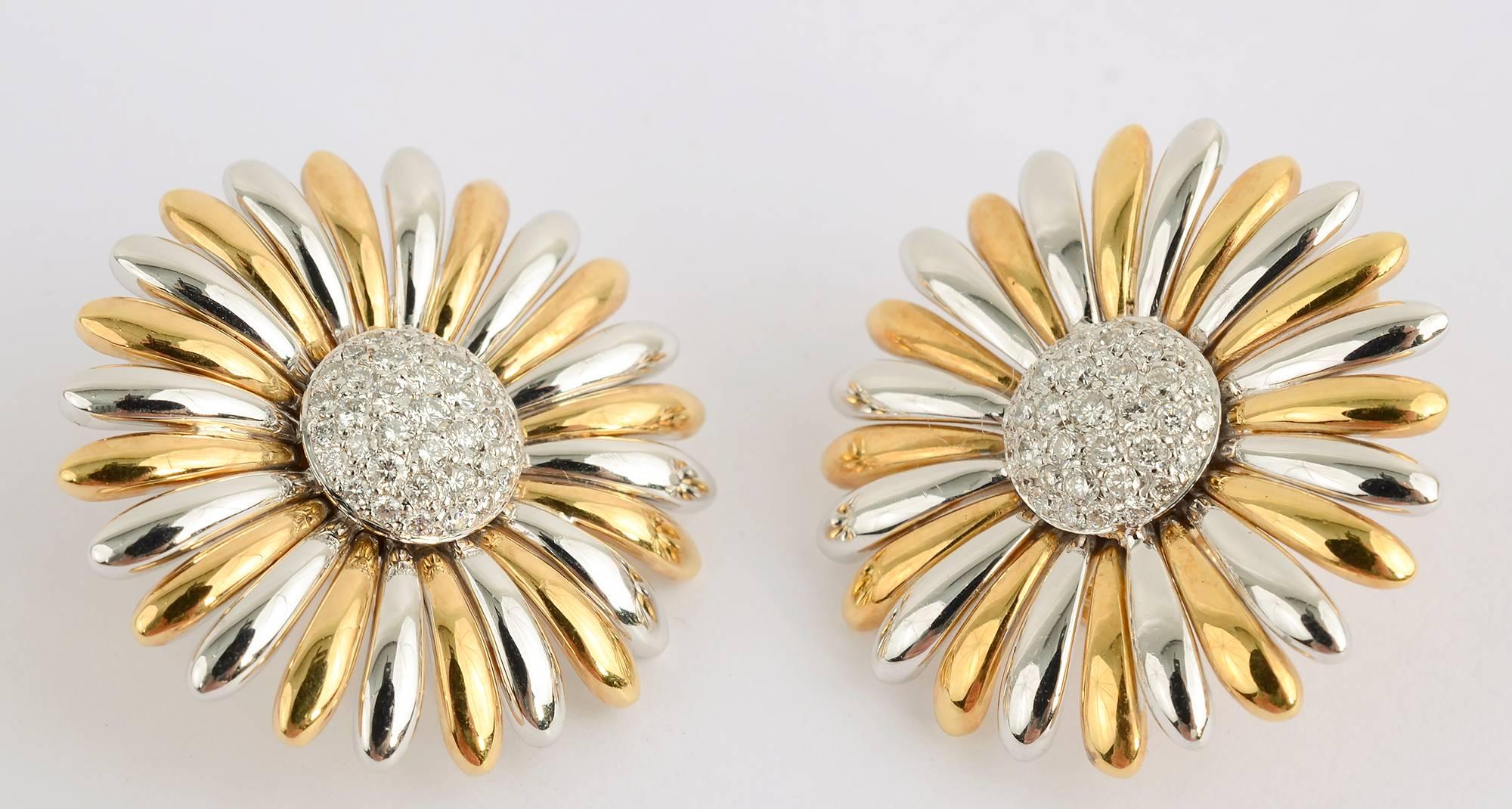 Stunning sunflower earrings by Asprey and Co. Flower petals alternate yellow and white gold. The sparkling centers are pave diamonds.
The backs are clips with retractable posts. The earrings are 1 1/8 inches in diameter.