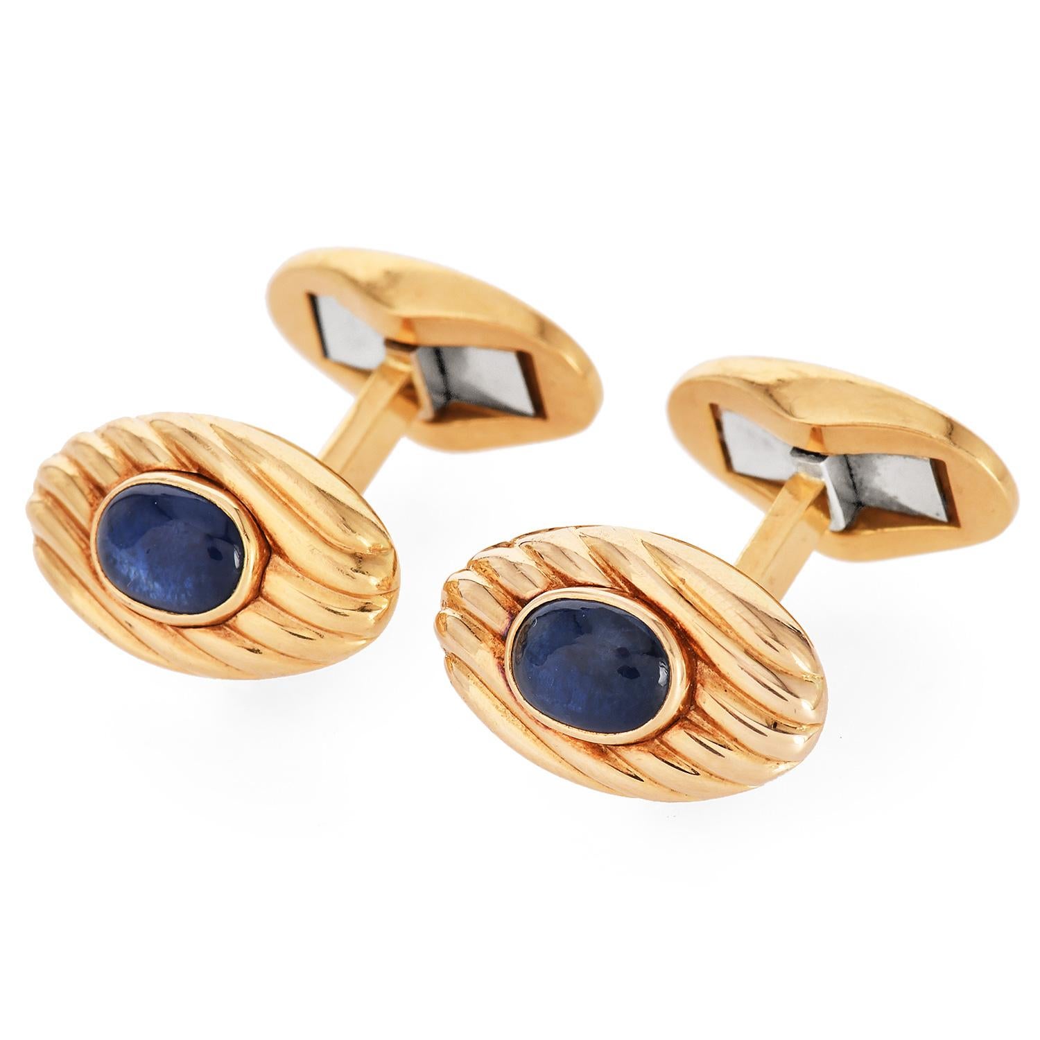Asprey Vintage Sapphire 18K Gold Oval Cuff Links forged in solid 18K yellow gold oval face Grooved pattern cuff links with natural cabochon cut sapphires bezel set in the center

Marked: 18K

Measurements: 17mmx10mm

Sapphire: oval Cabochon