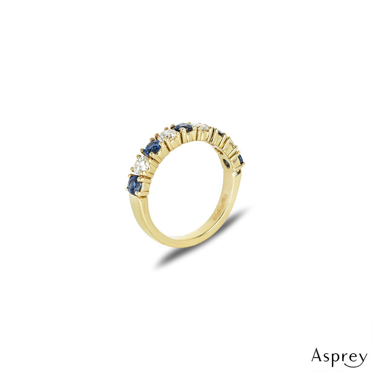 A lovely 18k yellow gold sapphire and diamond half eternity ring by Asprey. The ring features an alternating design of sapphires and diamonds in a four prong setting. The 5 round cut sapphires have an approximate total weight of 0.90ct and display a