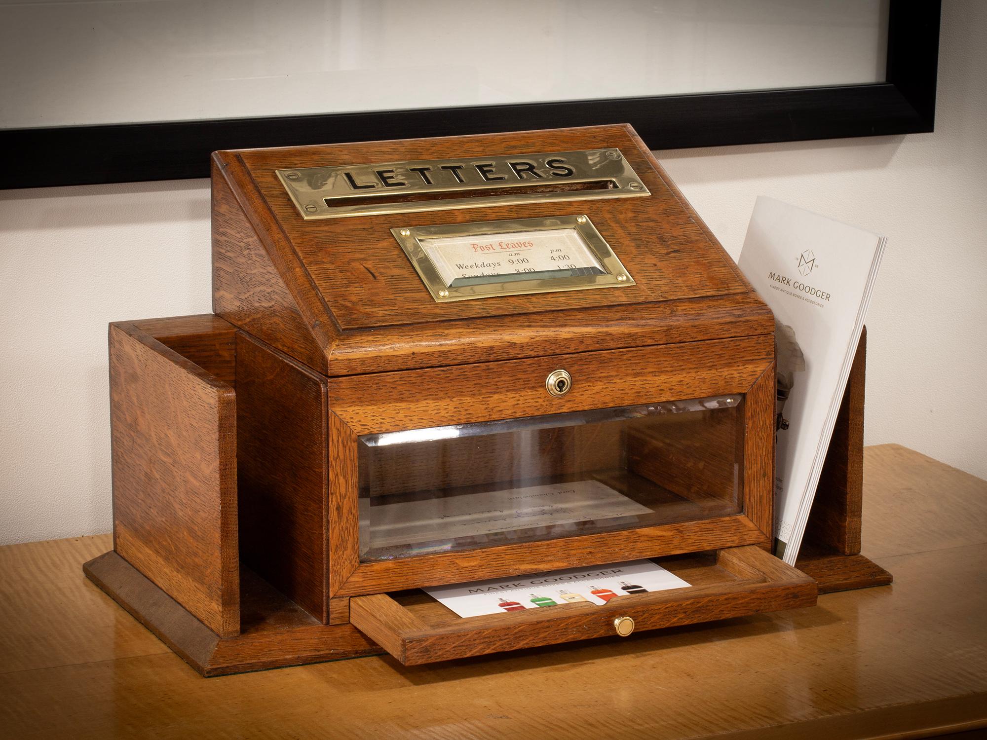 The Aspreys Letter Box is made from solid oak with a central letter box flanked by two small shelves for storing books or documents. The Letter Box is fitted with a rectangular brass face which contains the word “letters” on with a small letter hole