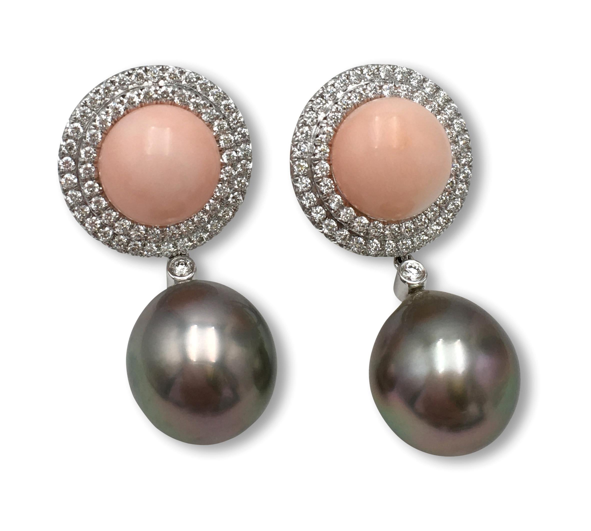A pair of Tahitian pearl and coral clip earrings set with approximately 1.25 carats total weight of round brilliant cut diamonds (F color, VS clarity). The pearls measure approximately 14.9 x 13.4mm. Coral measures approximately 11 x 7mm. Signed