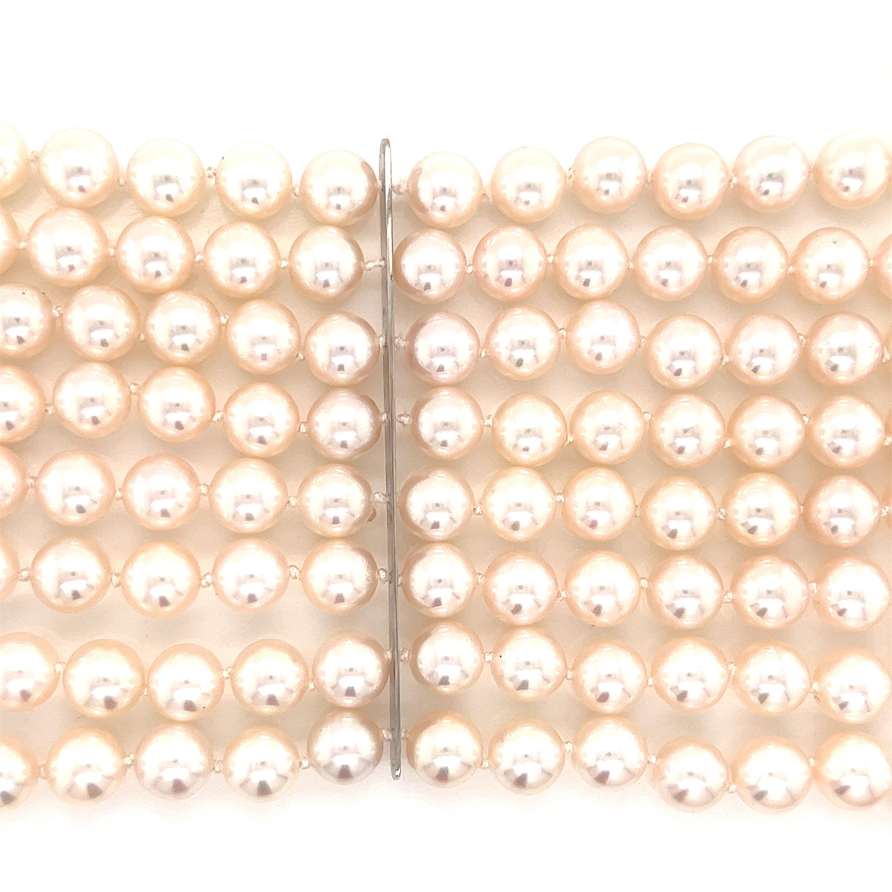 This extraordinary Assael vintage pearl and diamond bracelet is eight rows of 8-8.5 mm fine Japanese Akoya pearls. Set in 151.38 grams of 18 karat white gold.  The clasp. 1.18 ctw of round diamonds in a flower motif.  The bracelet is 7.5