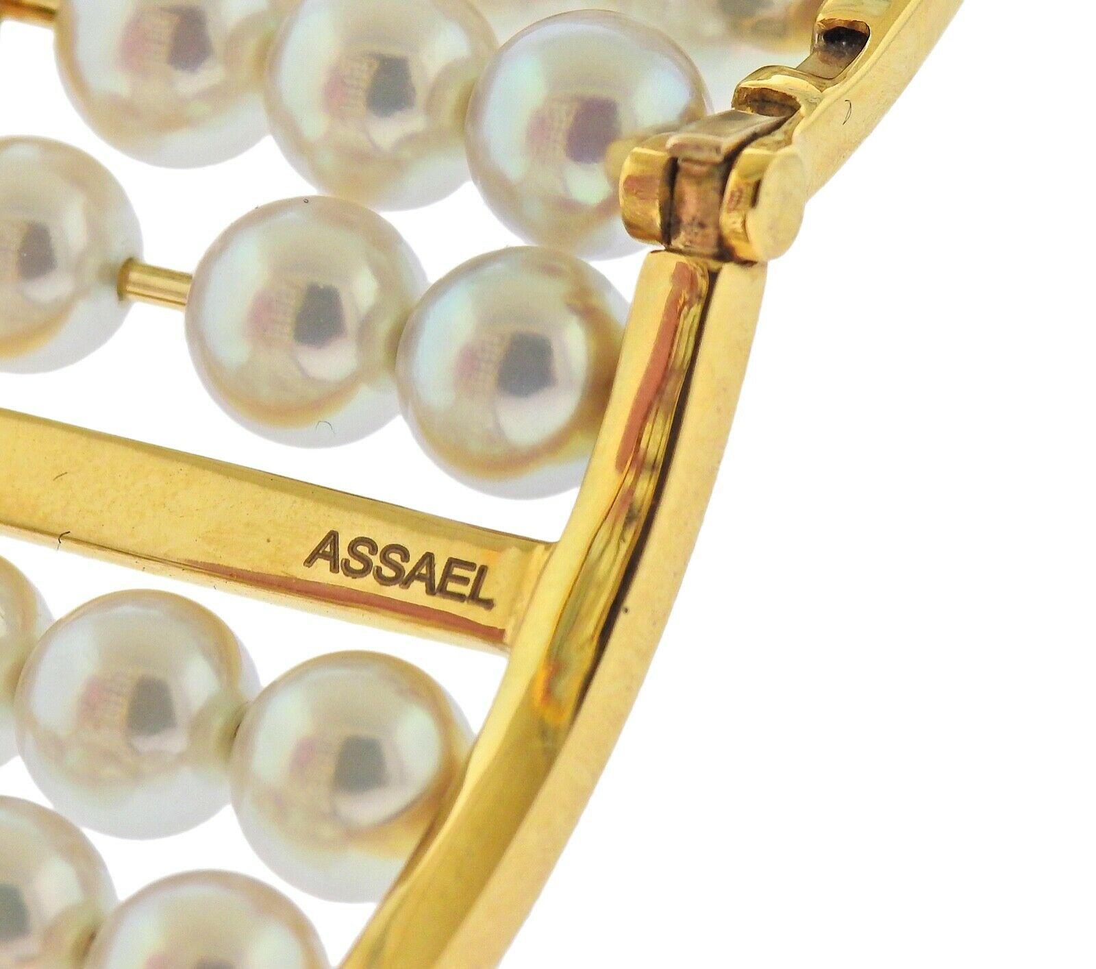 18k yellow gold bangle bracelet by Assael, set with 8mm akoya pearls. Bracelet will fit approx. 7