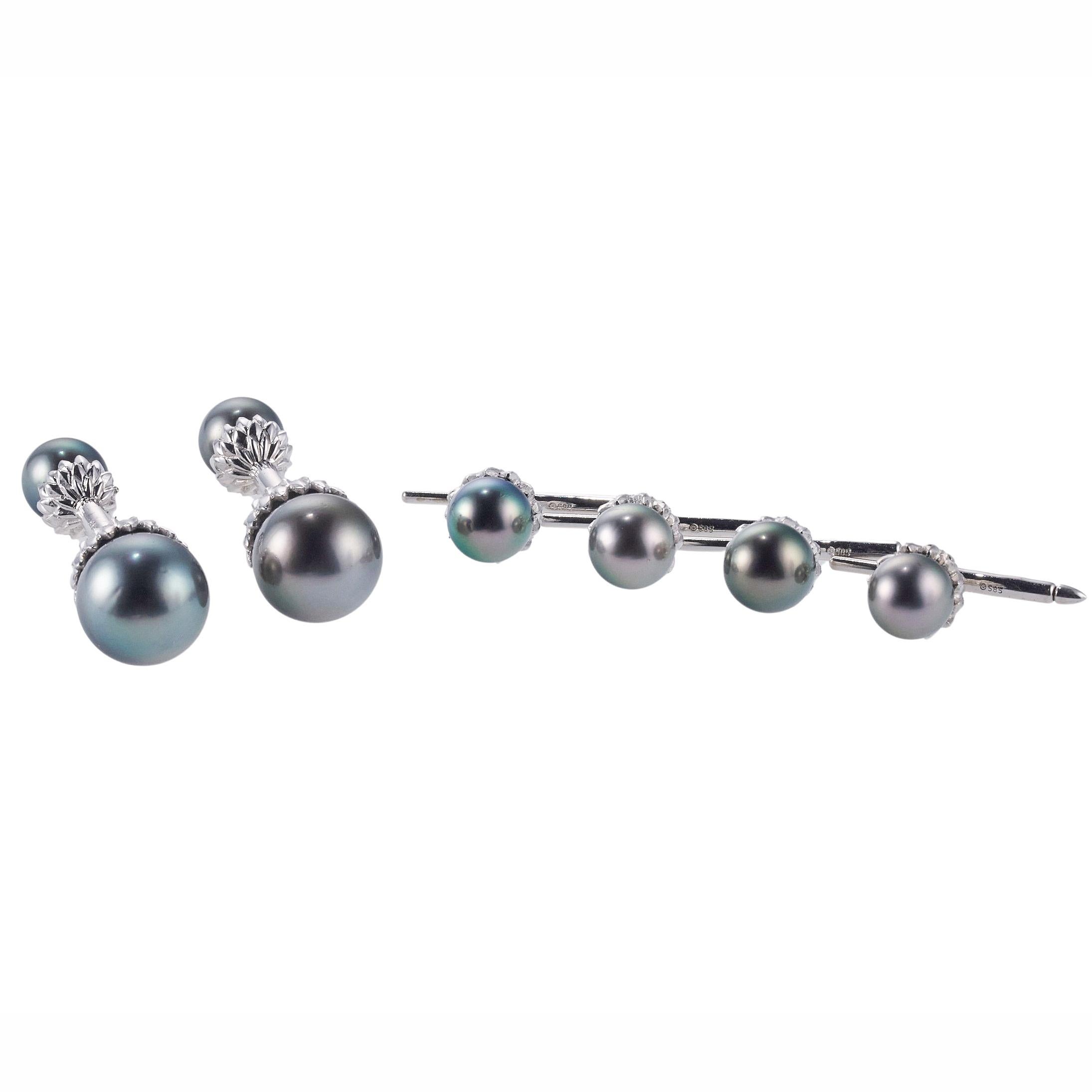18K white gold cufflinks and stud set by Assael, made with 9mm - 13mm Tahitian South Sea Pearls. Cufflink top measures 13mm, back is 9mm; Stud top is 9.3mm. Weight is 32.4 grams. Marked: 18k, 585 (stud hardware). Retail Value $9500.