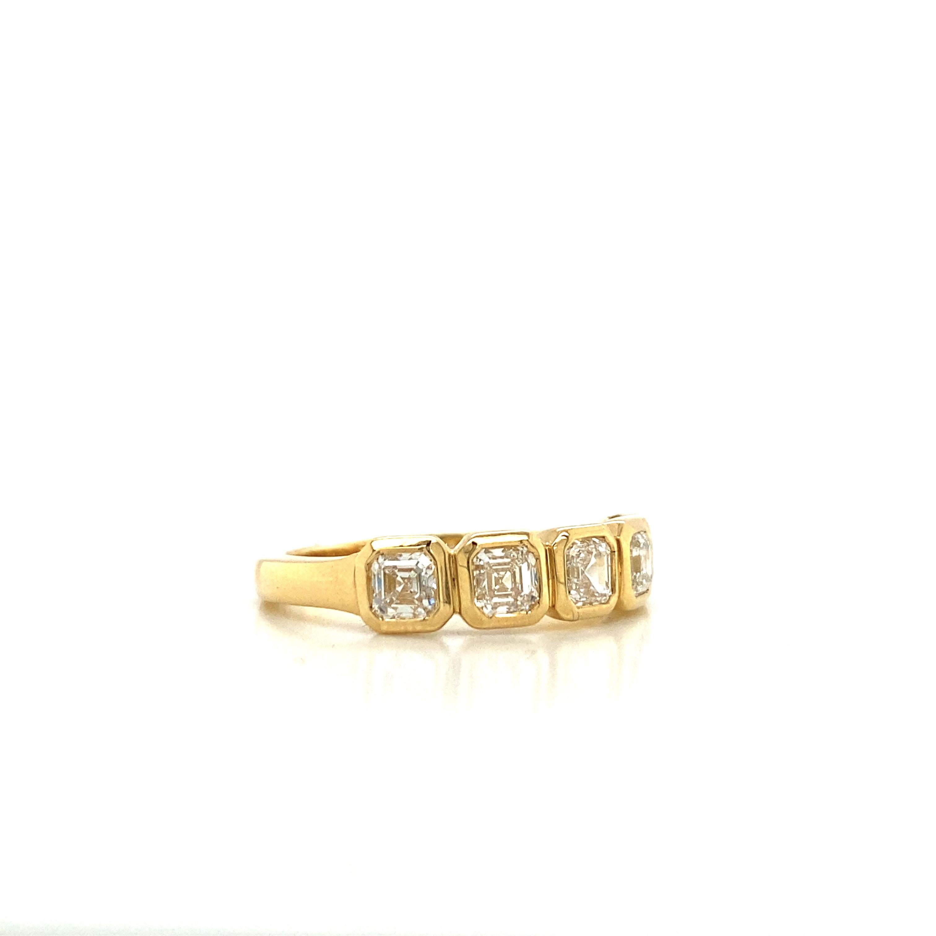 This Asscher Diamond Anniversary Band features 5 Asscher Diamonds, weighing 1.10 Total Carat Weight. These stones are set in a Bezel Setting that outlines the shape and corners, giving the ring a beautiful appearance. The diamonds are F Color, VS