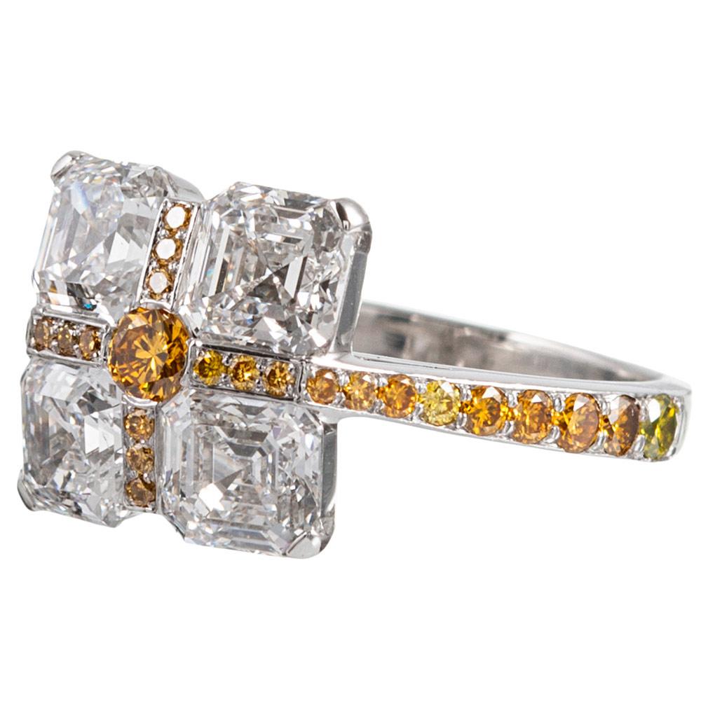 A unique and creative creation, rendered in platinum and set with four asscher cut diamonds, 3.80 cttw that are intersected with 31 yellow diamonds, .44cttw. This is artful and unusual fine jewelry with a slick low profile, allowing it to be