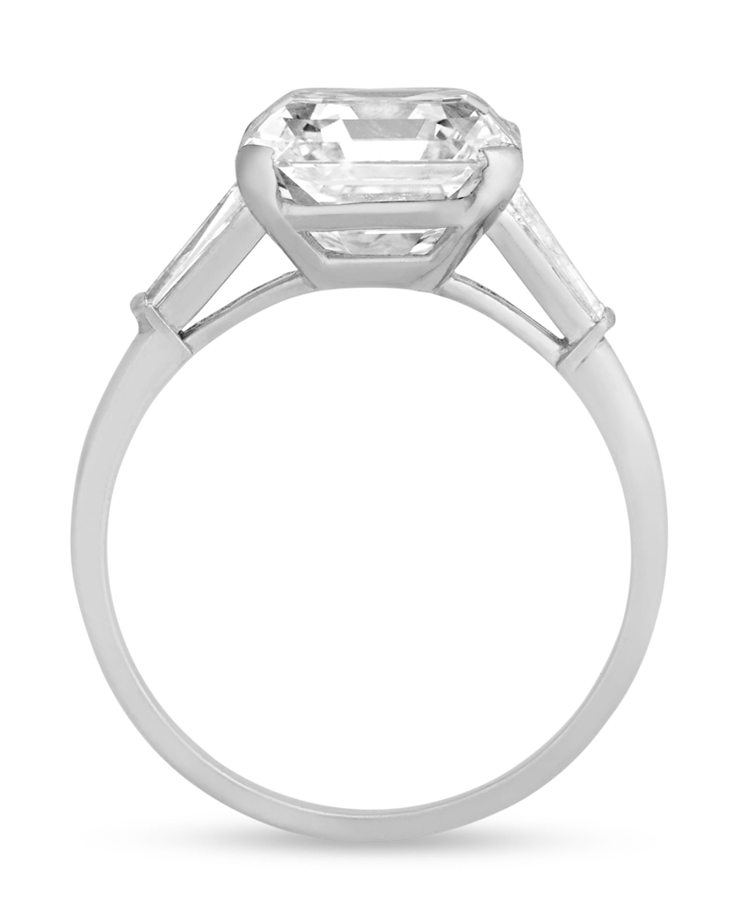 Remarkably reflective and brilliant, the Asscher-cut diamond at the center of this ring from famed American jeweler Raymond Yard weighs an impressive 6.20 carats. The patented 74-facet step cut arrangement results in a distinctive, sparkling effect